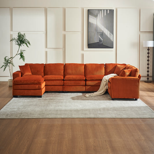 Plush orange corduroy sectional sofa with Ushaped configuration and accent pillows for a cozy living room