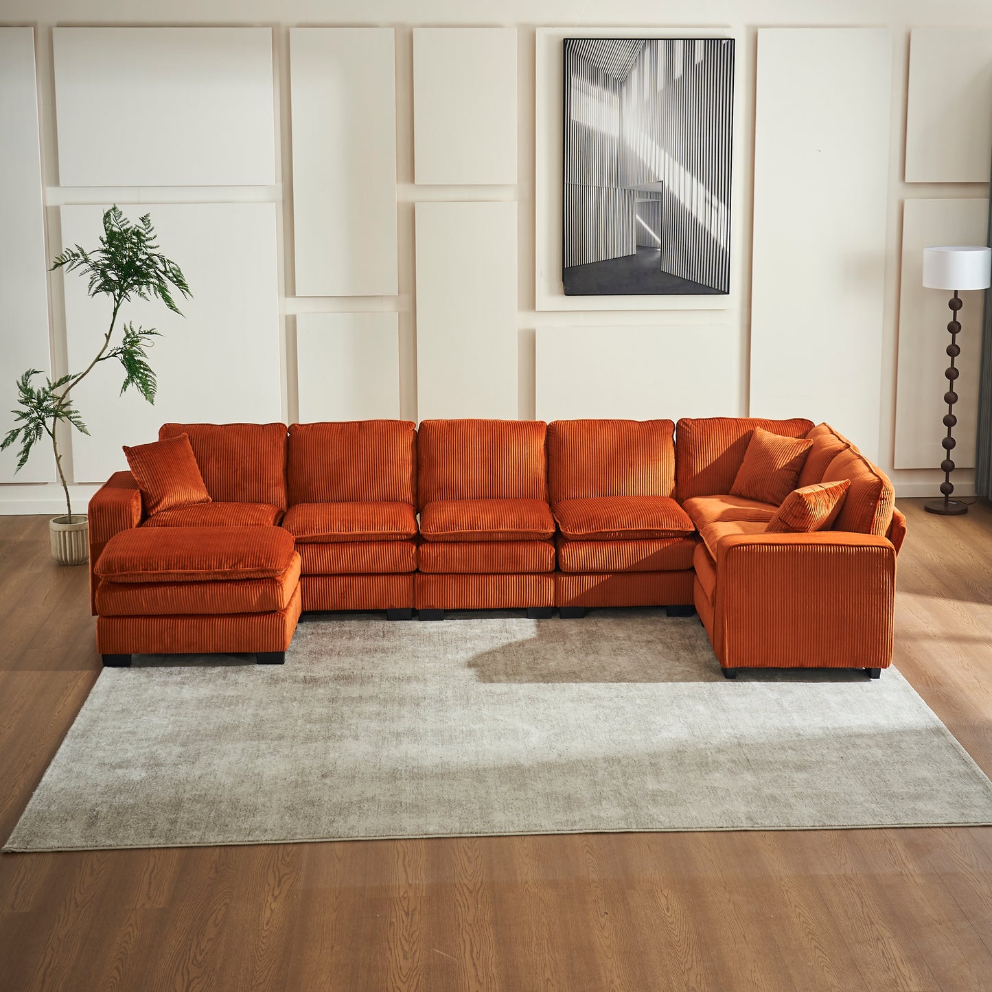 Orange corduroy sectional sofa with plush cushions and an ottoman