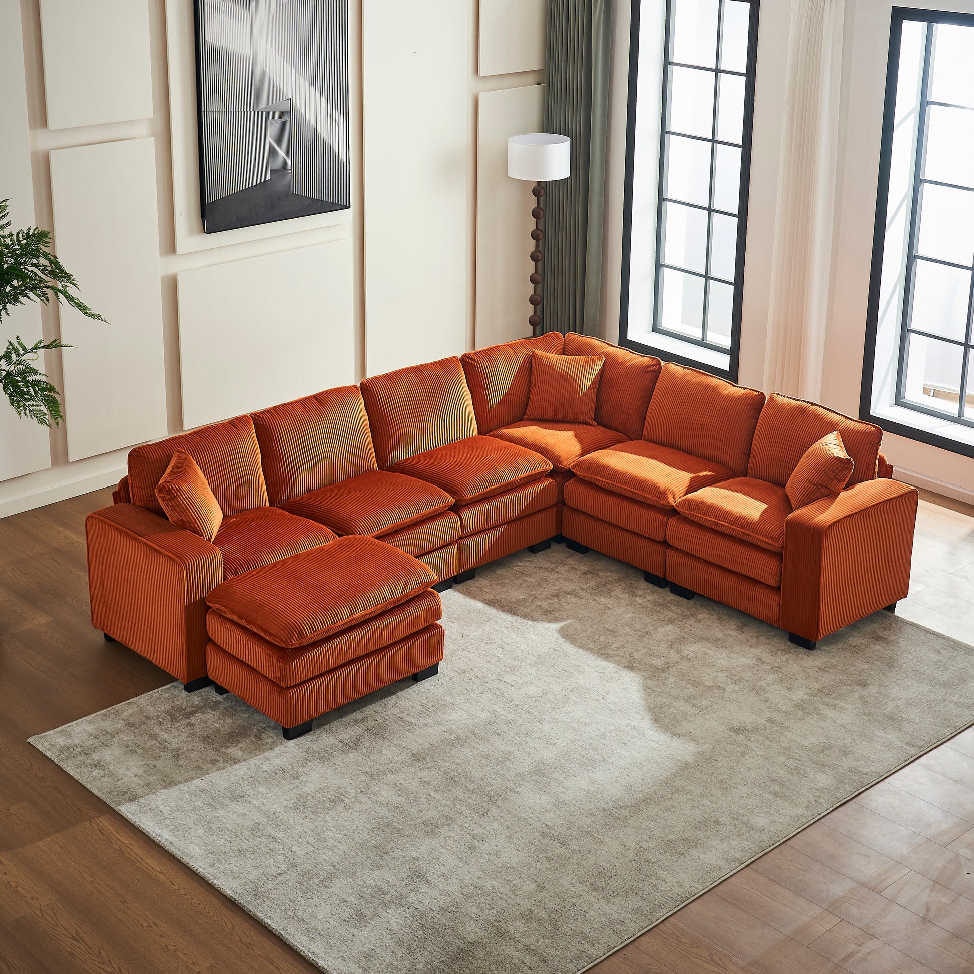 Orange corduroy sectional sofa with ottoman for a spacious living room