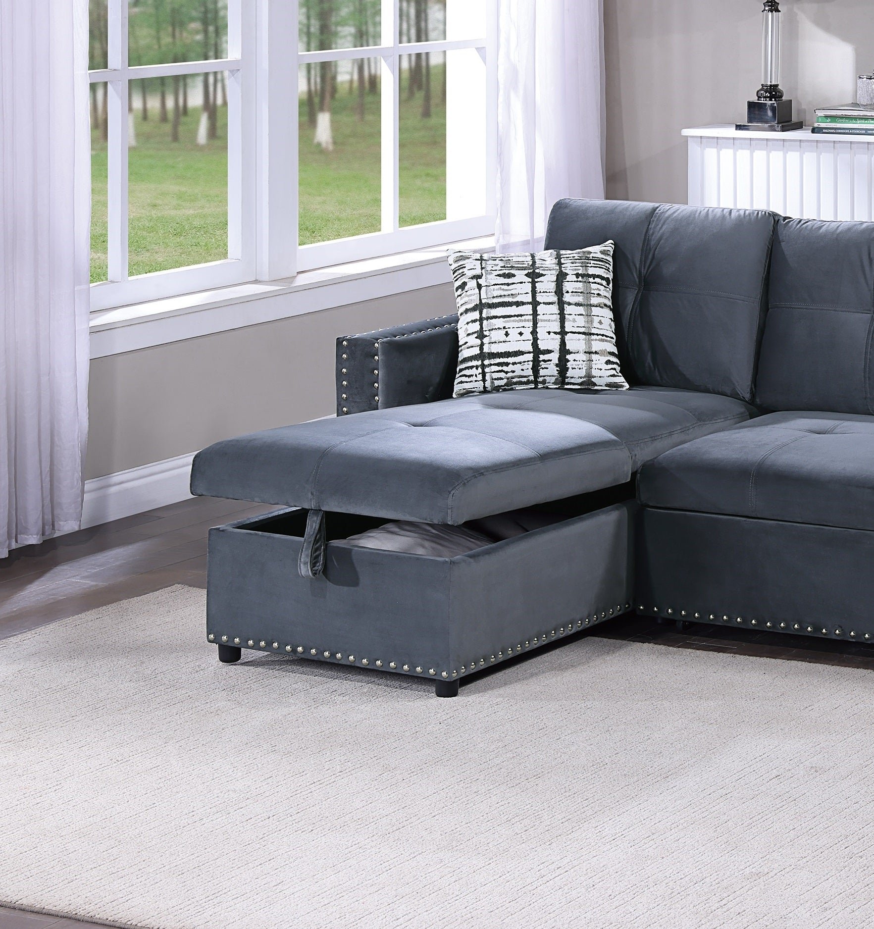 Dark grey velvet sectional sofa with tufted seats and storage chaise