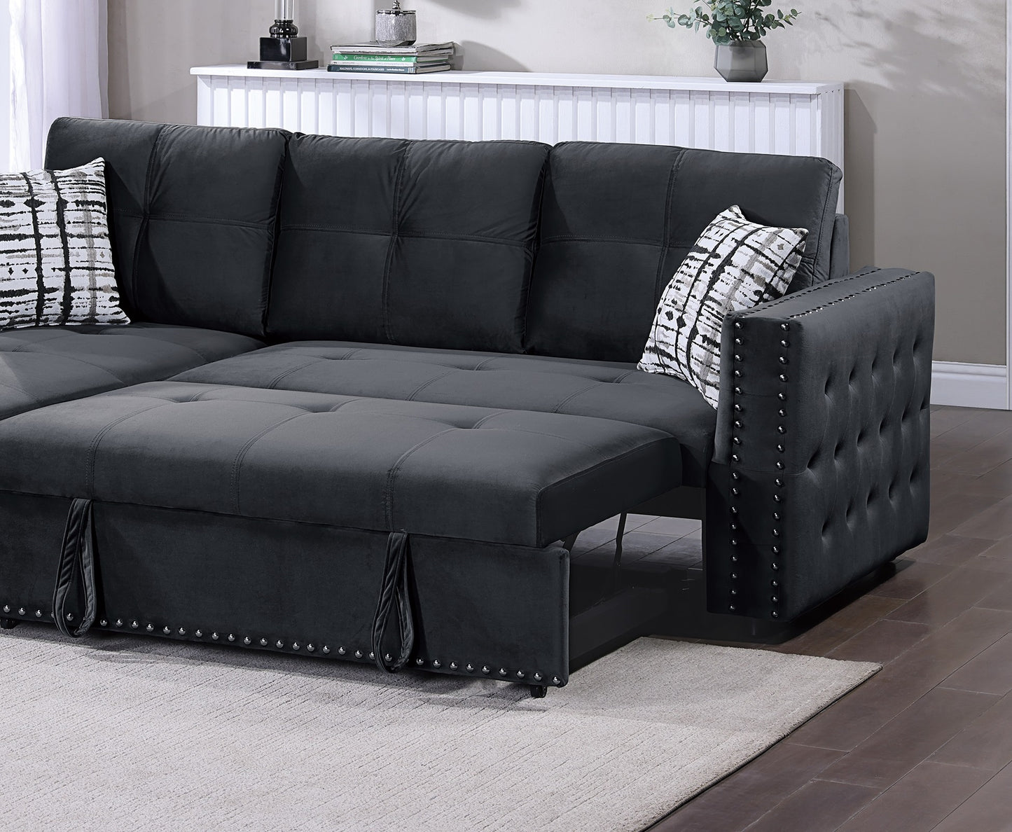 Dark gray velvet sectional sofa with tufted armrest and pullout bed feature
