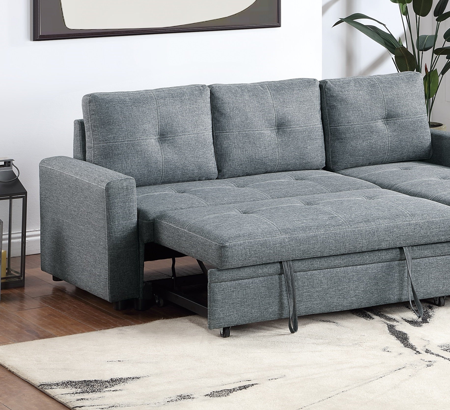 Gray sectional sofa with tufted cushions and pullout bed feature
