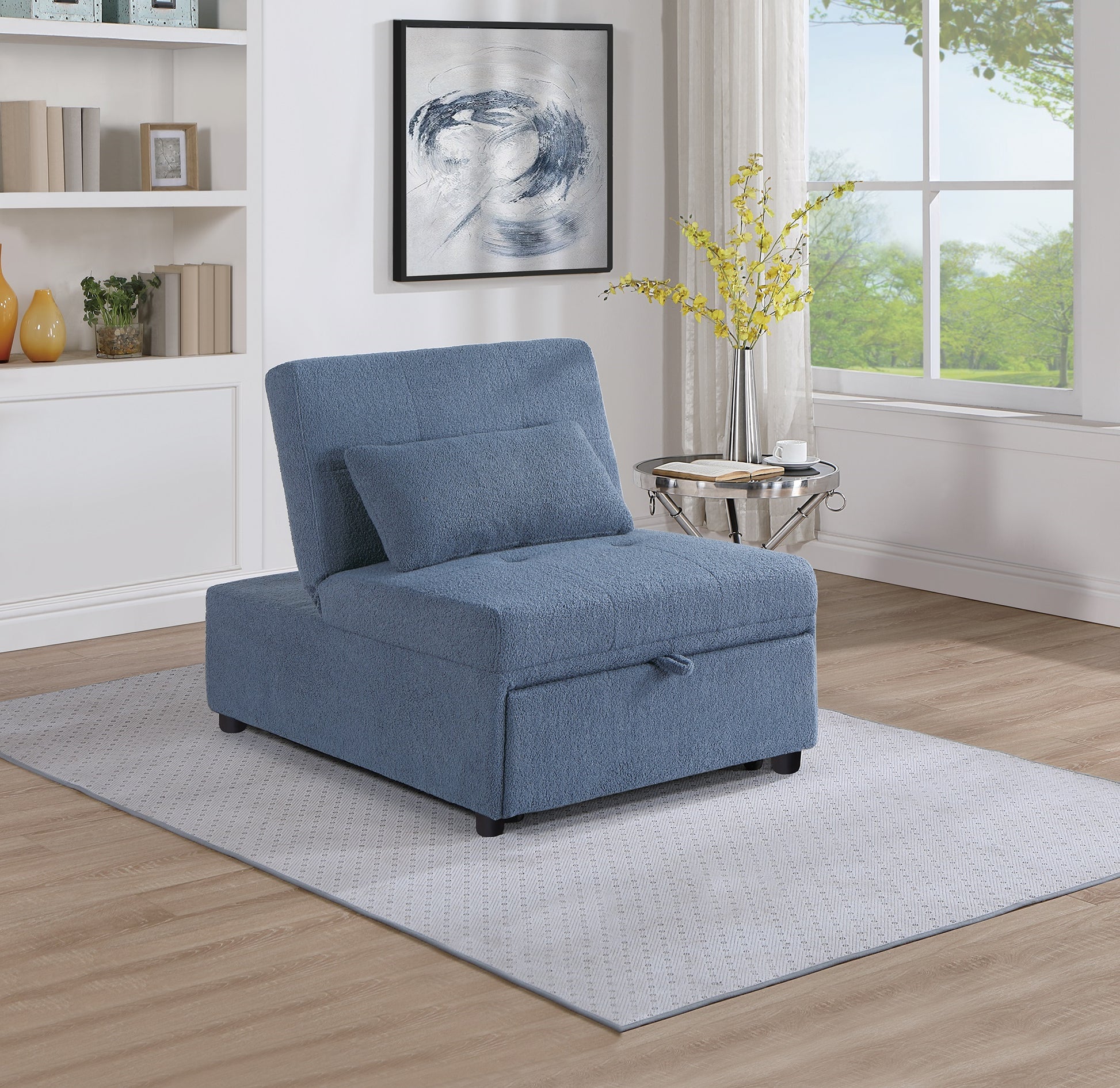 Blue upholstered convertible chair with storage featuring a tufted seat and pullout handle for easy access