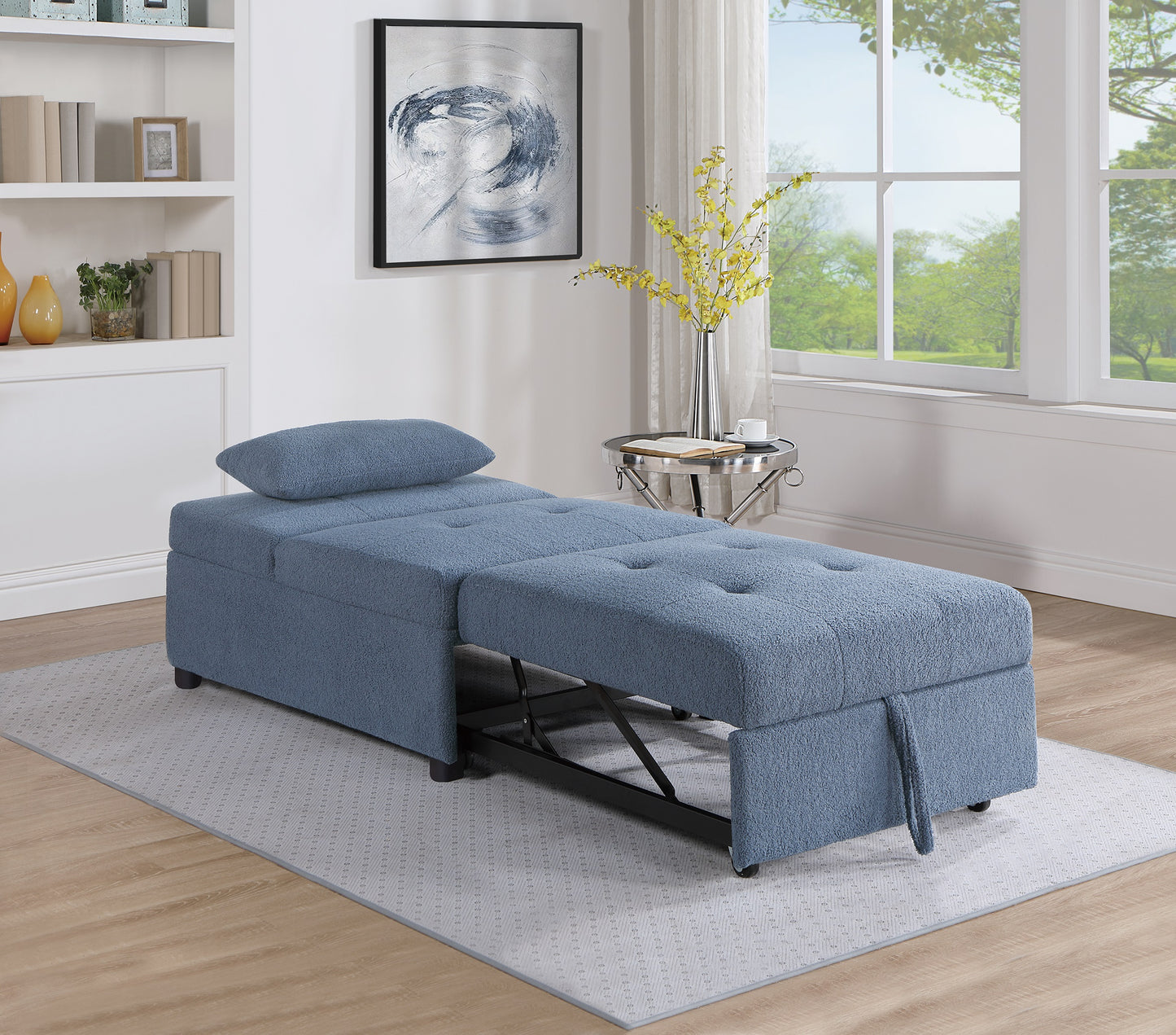 Blue upholstered convertible sofa bed with tufted seat cushions and storage ideal for small spaces
