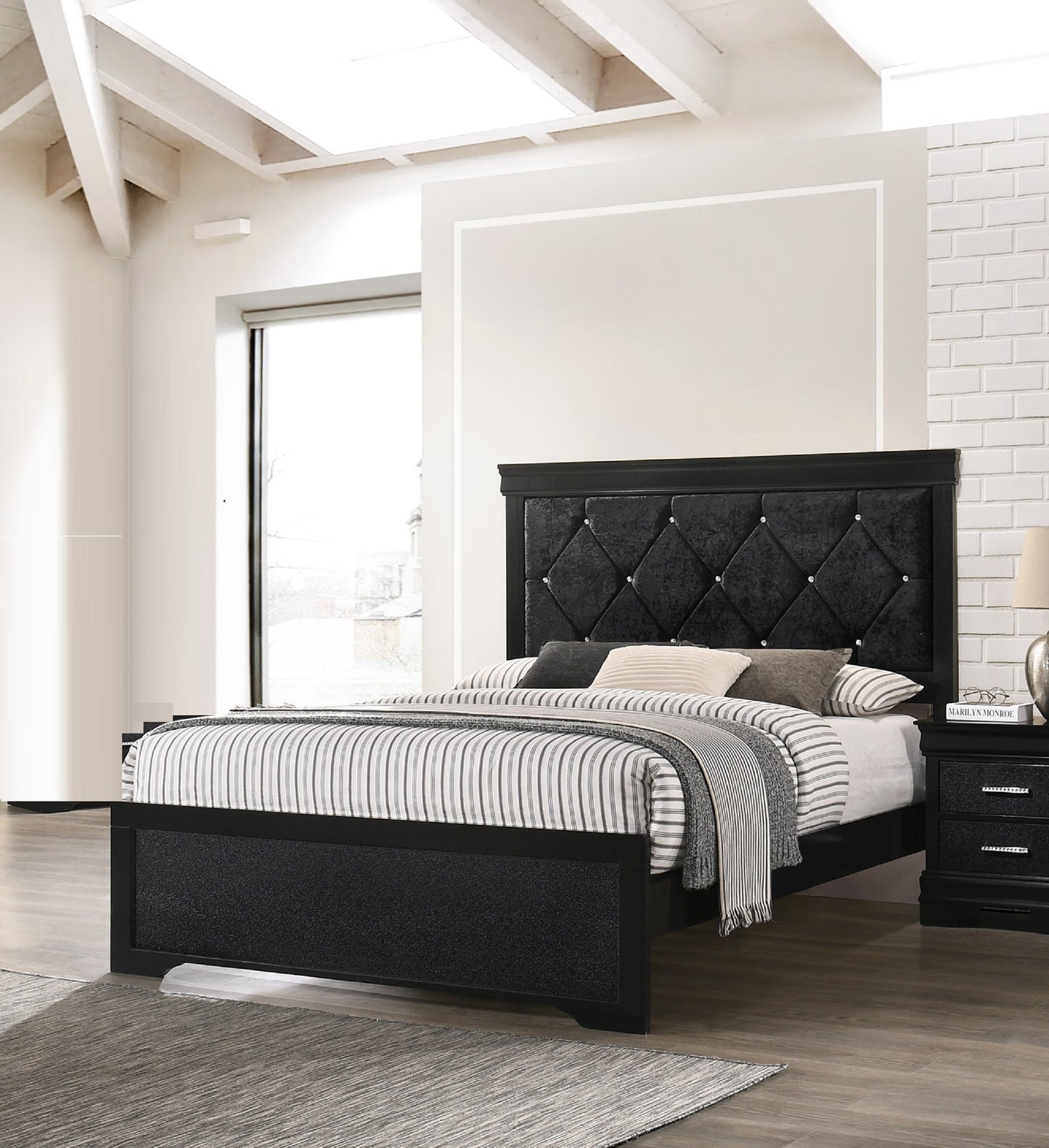 Black velvet upholstered platform bed with diamond tufting and crystal accents