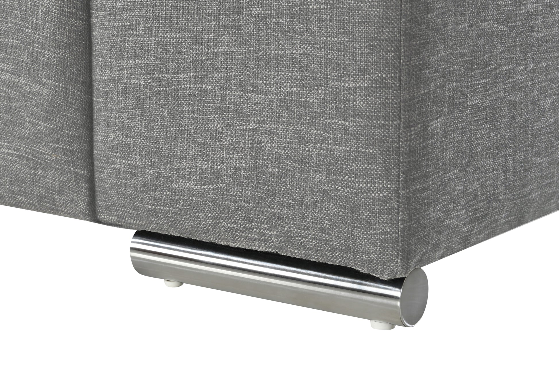 Closeup of a grey fabric couch with a modern chrome leg detail
