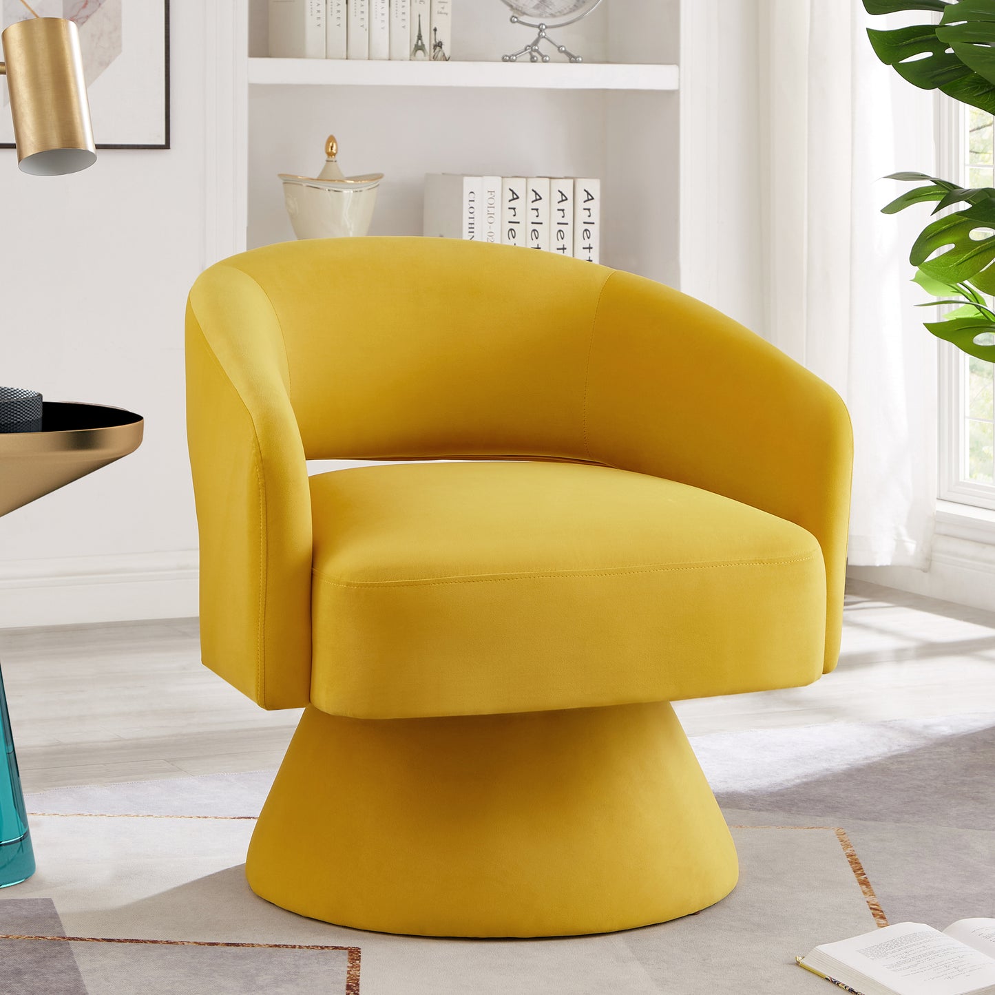 Yellow velvet accent chair with a rounded back and swivel base for modern living spaces