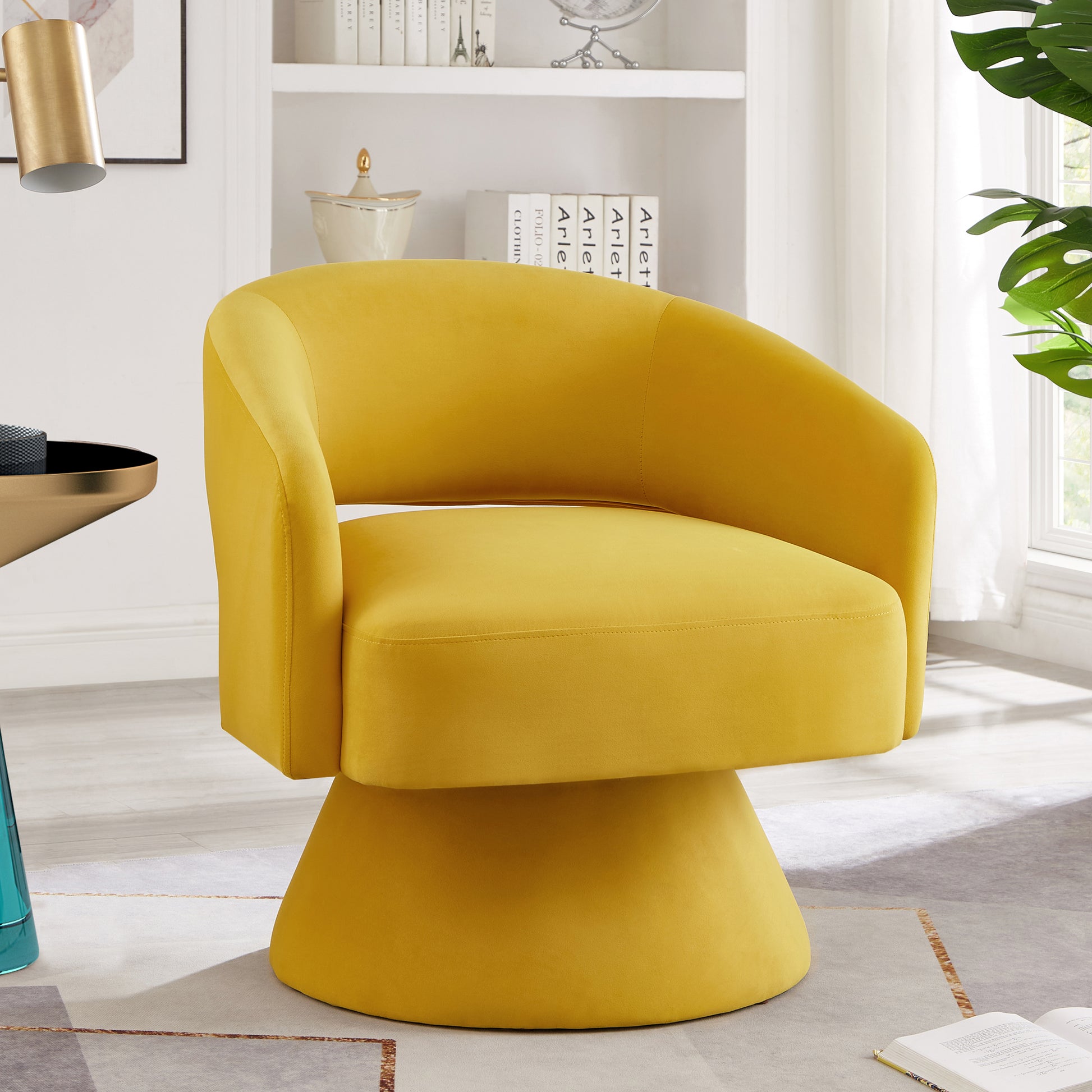 Yellow velvet accent chair with a rounded back and swivel base for modern living spaces