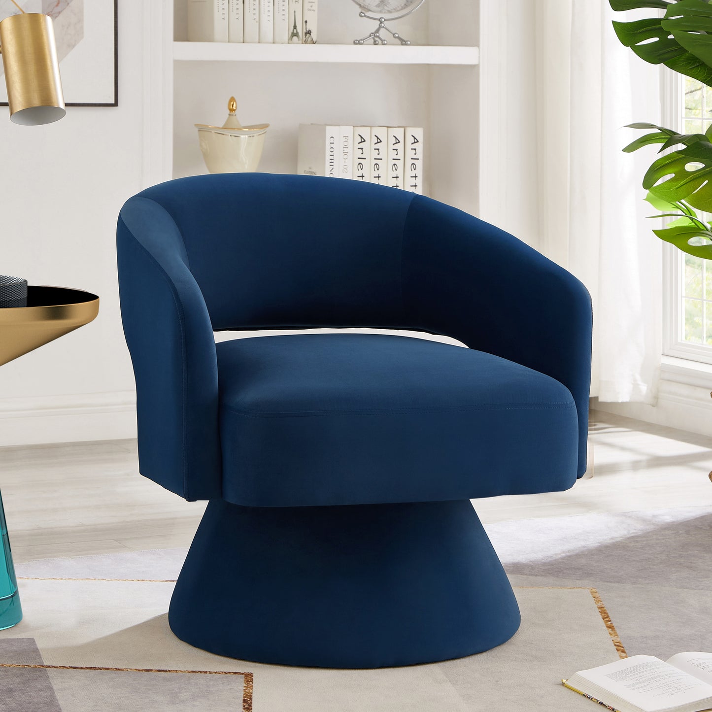 Navy blue velvet swivel chair with a flared base perfect for a modern living room accent