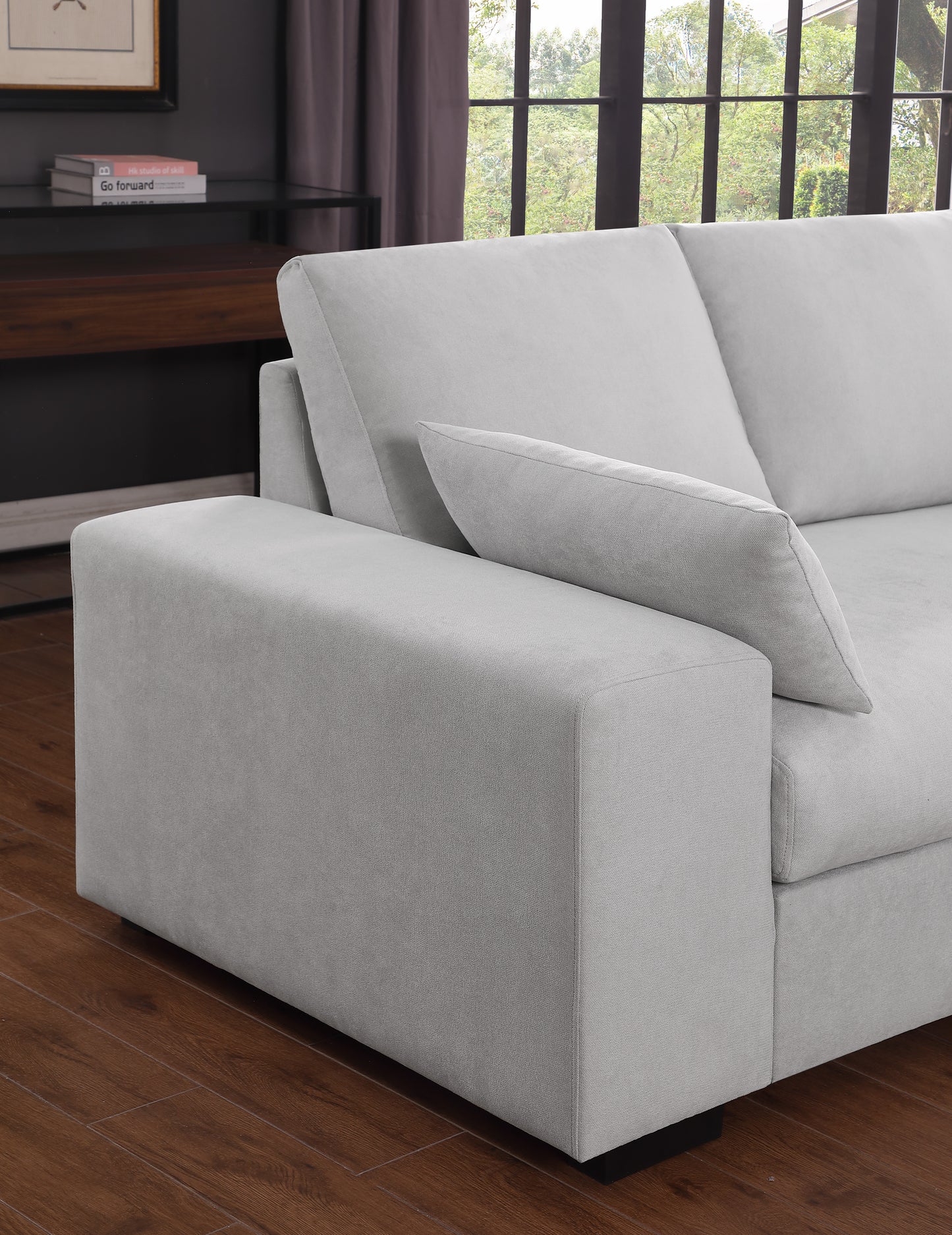 Light grey fabric sofa with deep seating and plush throw pillow