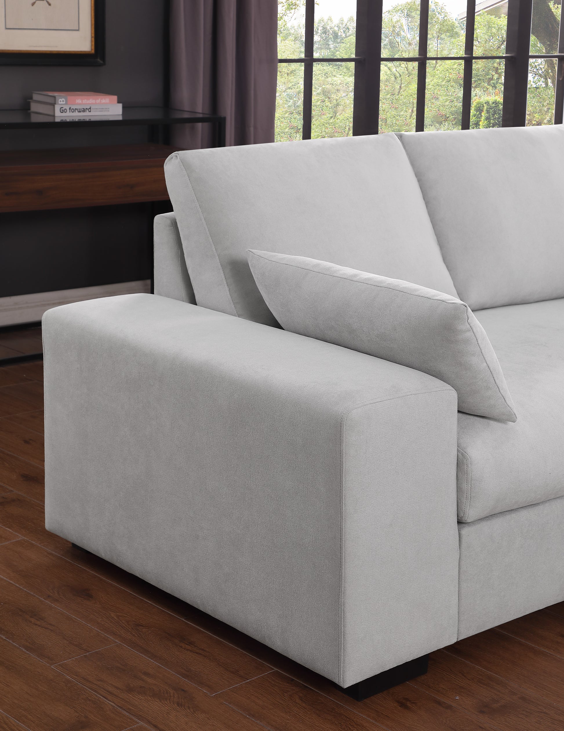 Light grey fabric sofa with deep seating and plush throw pillow