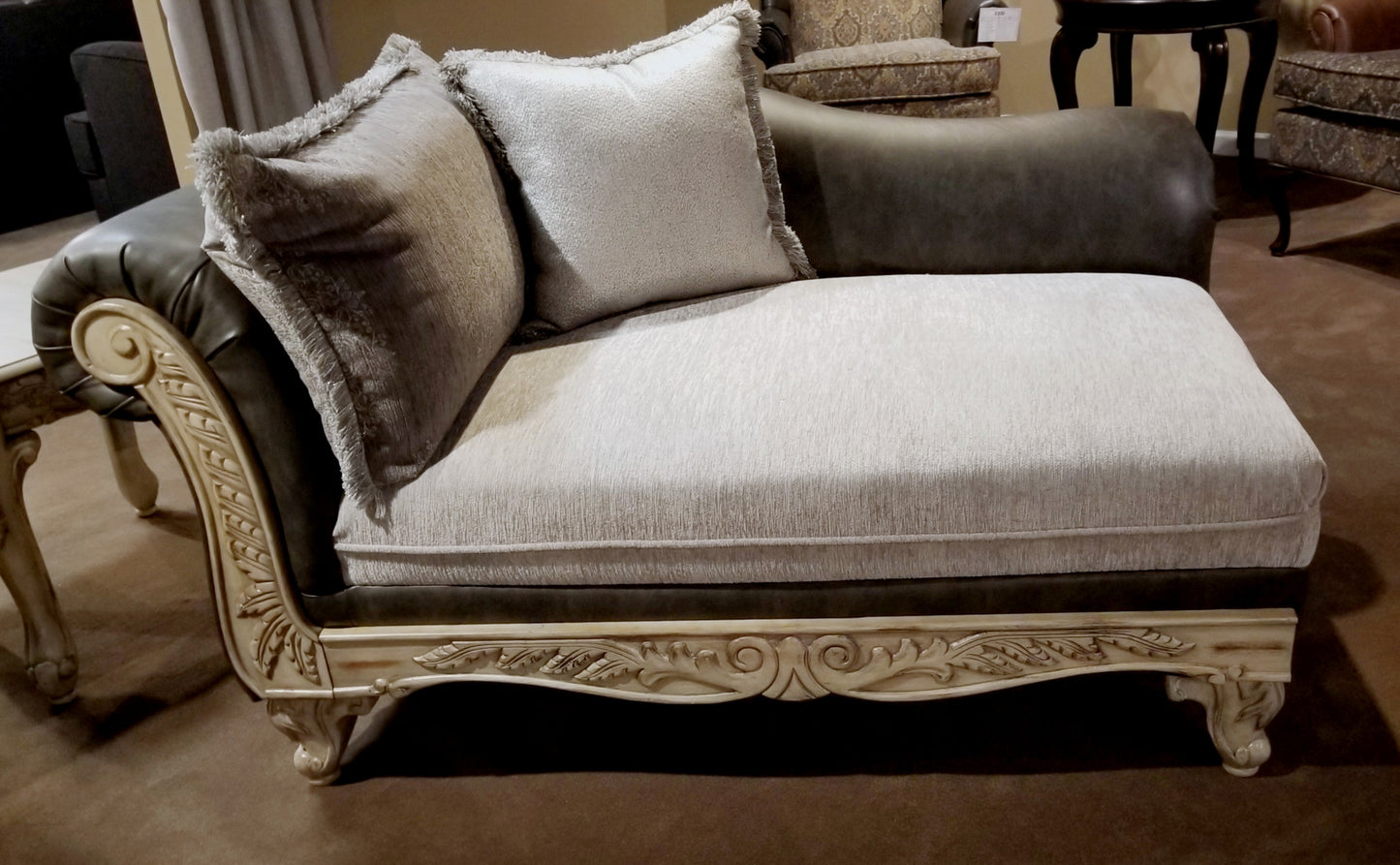 Elegant chaise lounge with ornate carved wood frame and plush fabric upholstery