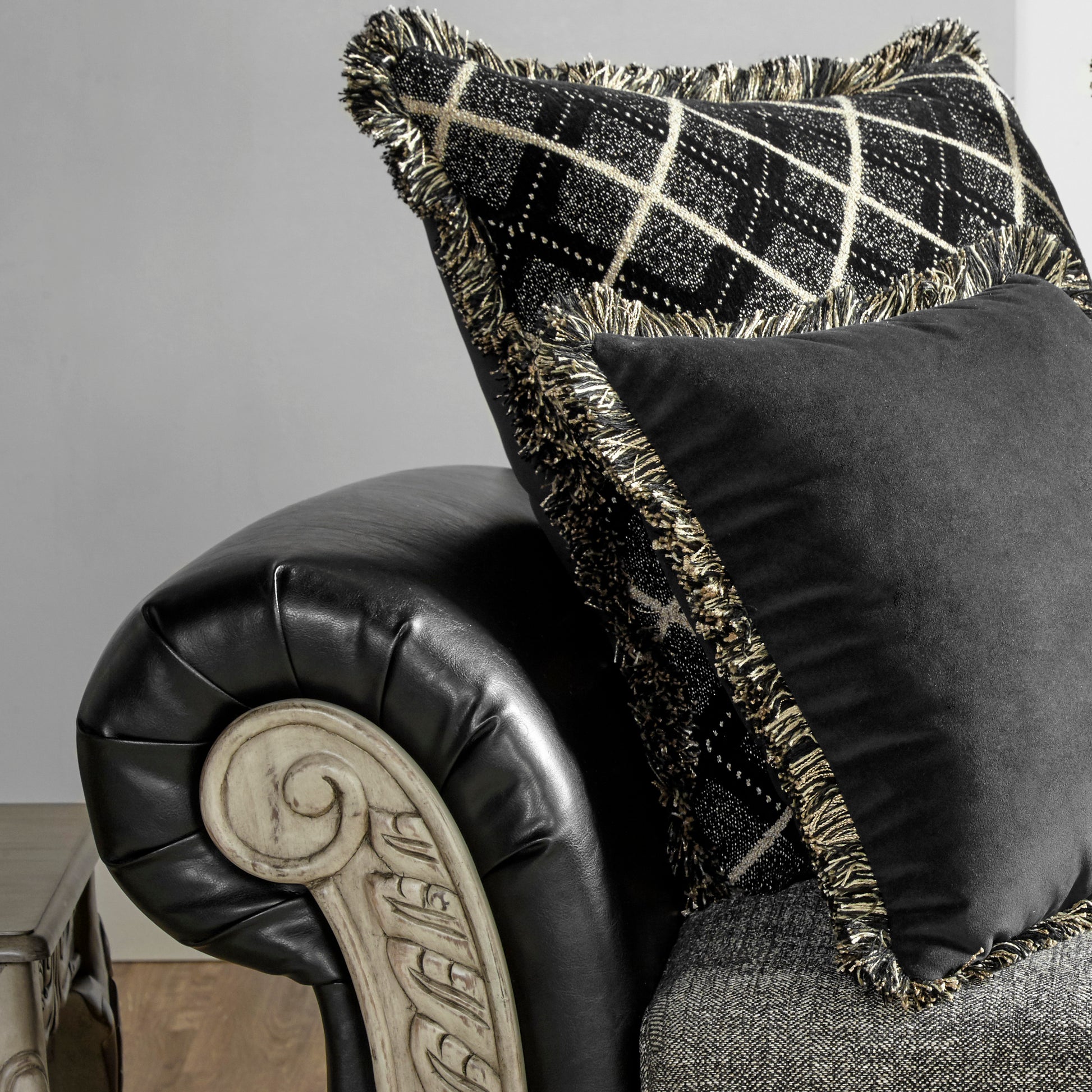 Black velvet pillow with gold fringe and diamond pattern