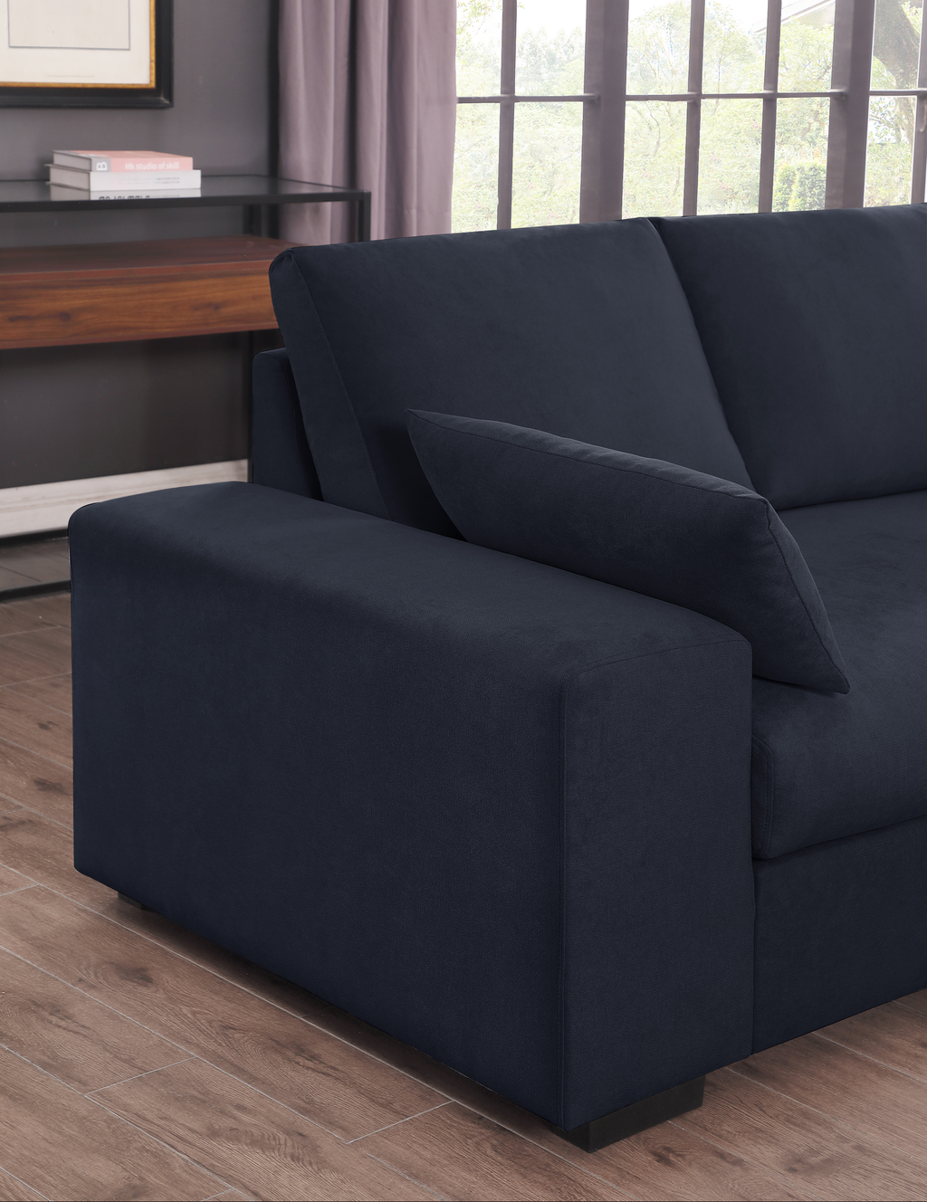 Deep navy blue fabric sectional sofa modern design with plush cushions and dark wood floor