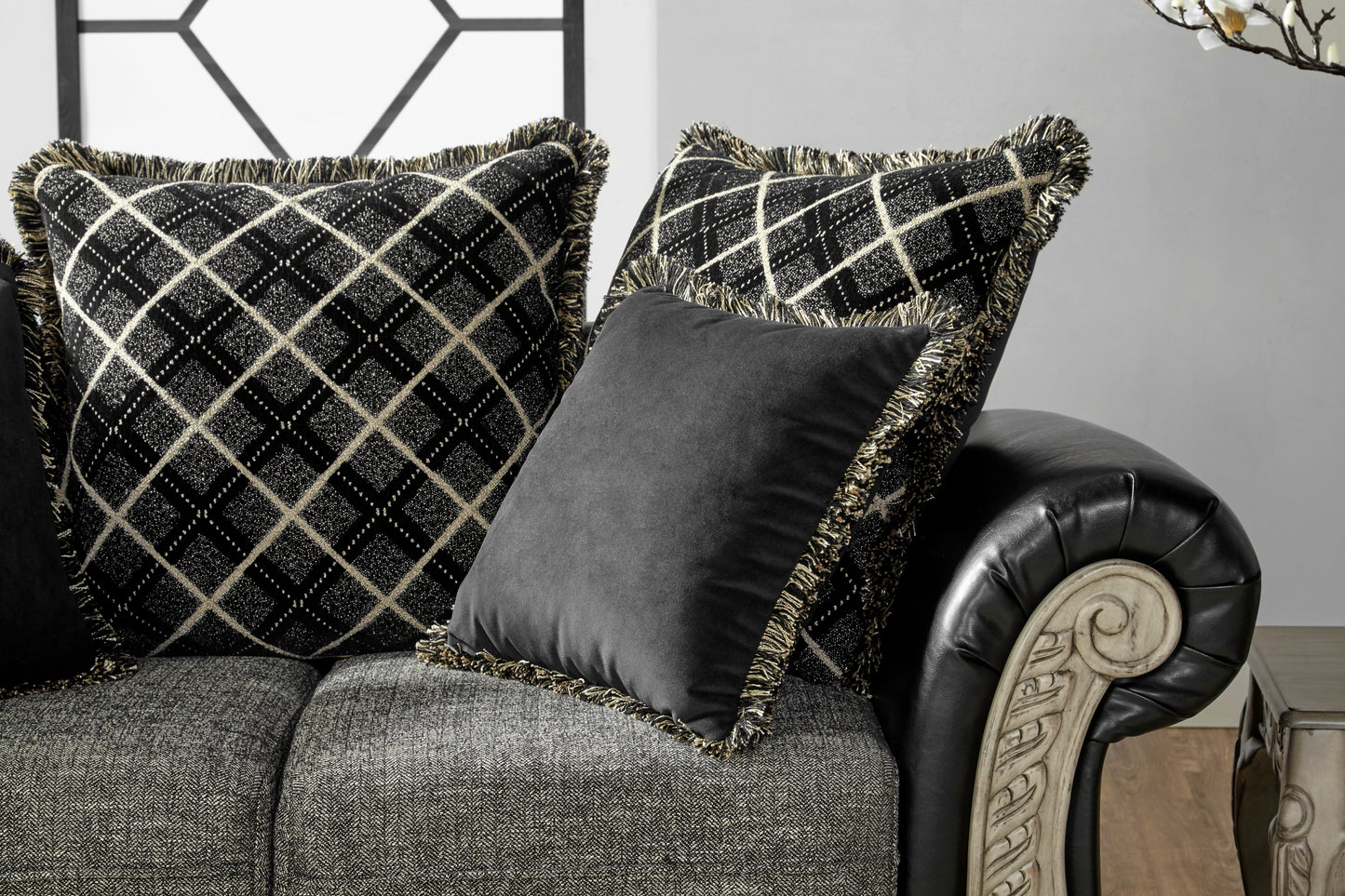 Black diamondpattern throw pillow with gold fringe detail