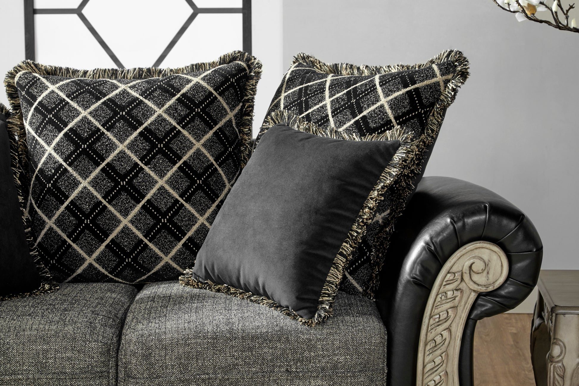 Black diamondpattern throw pillow with gold fringe detail