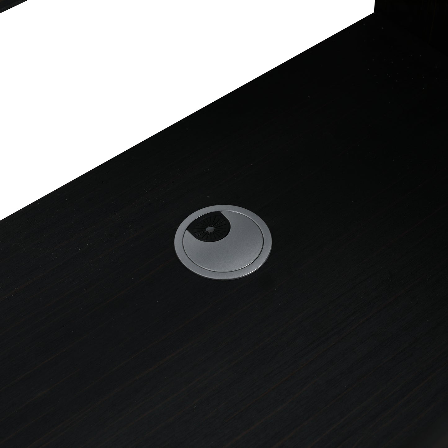Dark wood desk with circular grommet for cable management