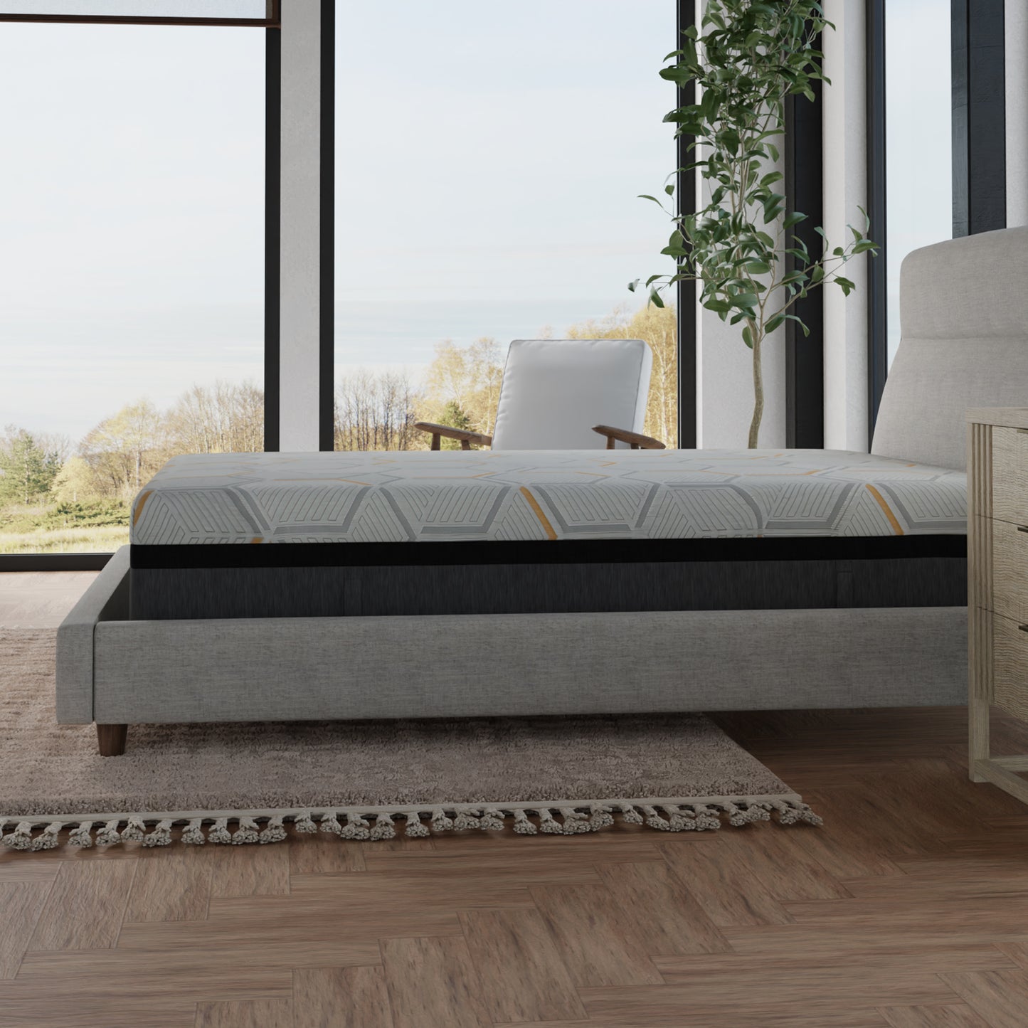 A grey upholstered bed with a layered mattress featuring a geometric pattern in white grey and yellow This comfortable mattress is perfect for a modern bedroom