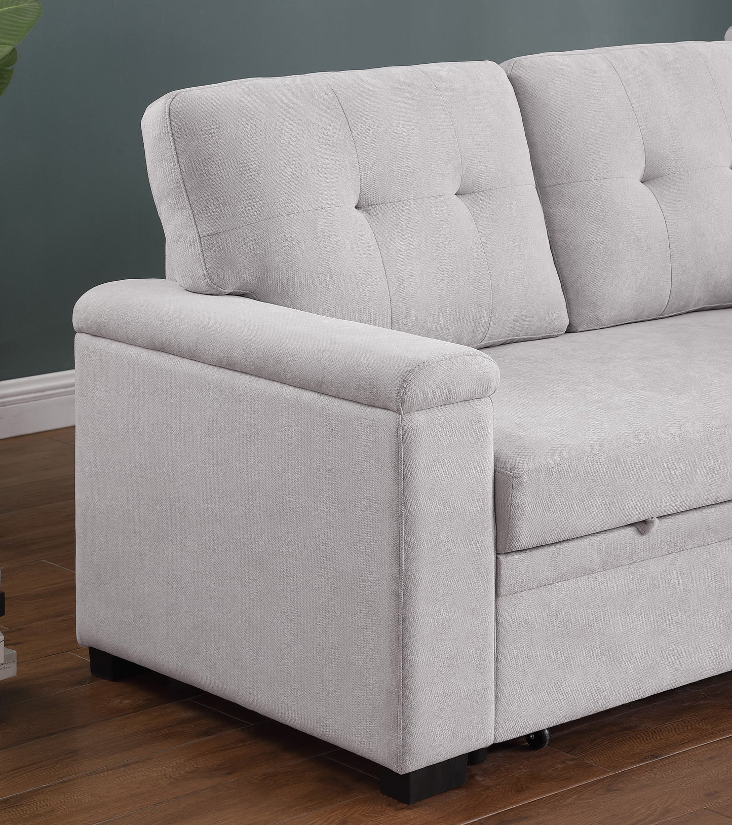 Light gray fabric sofa with tufted back cushions and a hidden storage compartment