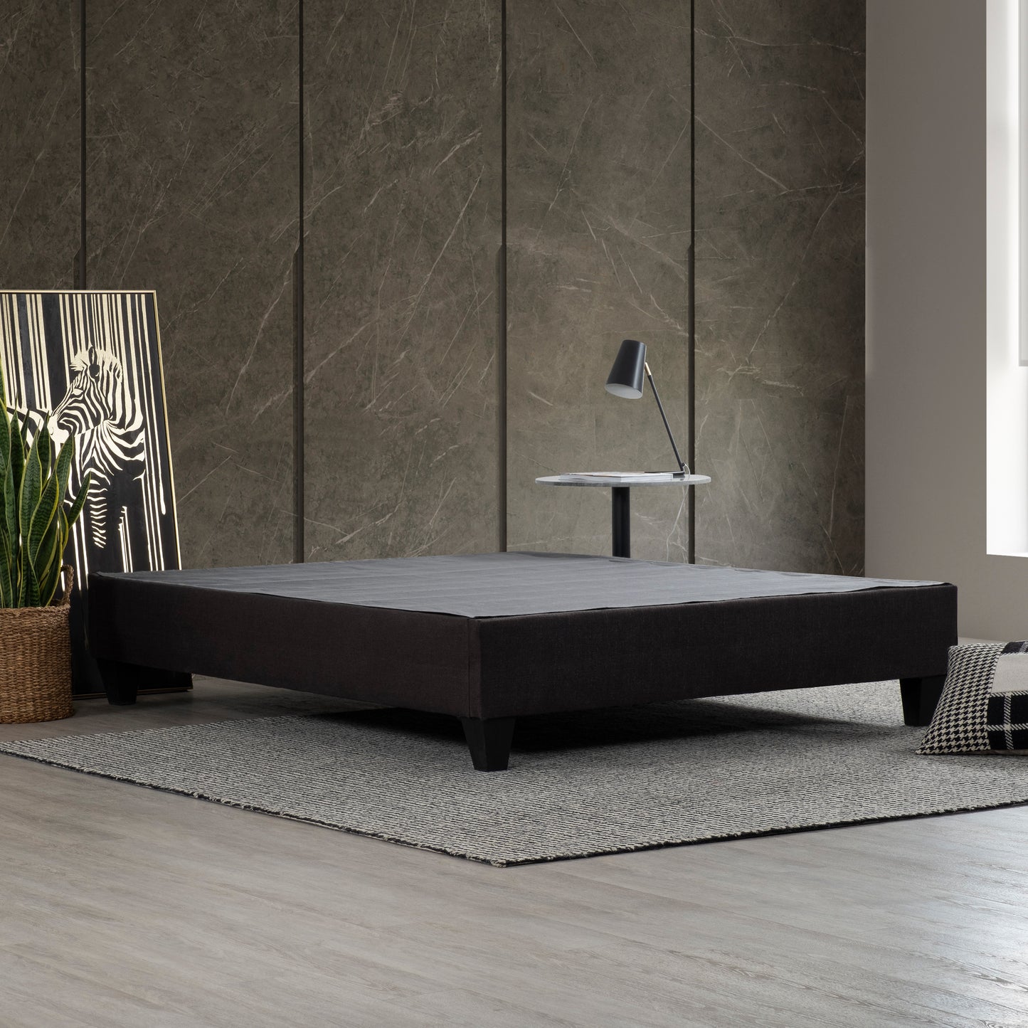 Dark gray upholstered platform bed frame with sleek legs offering modern bedroom style