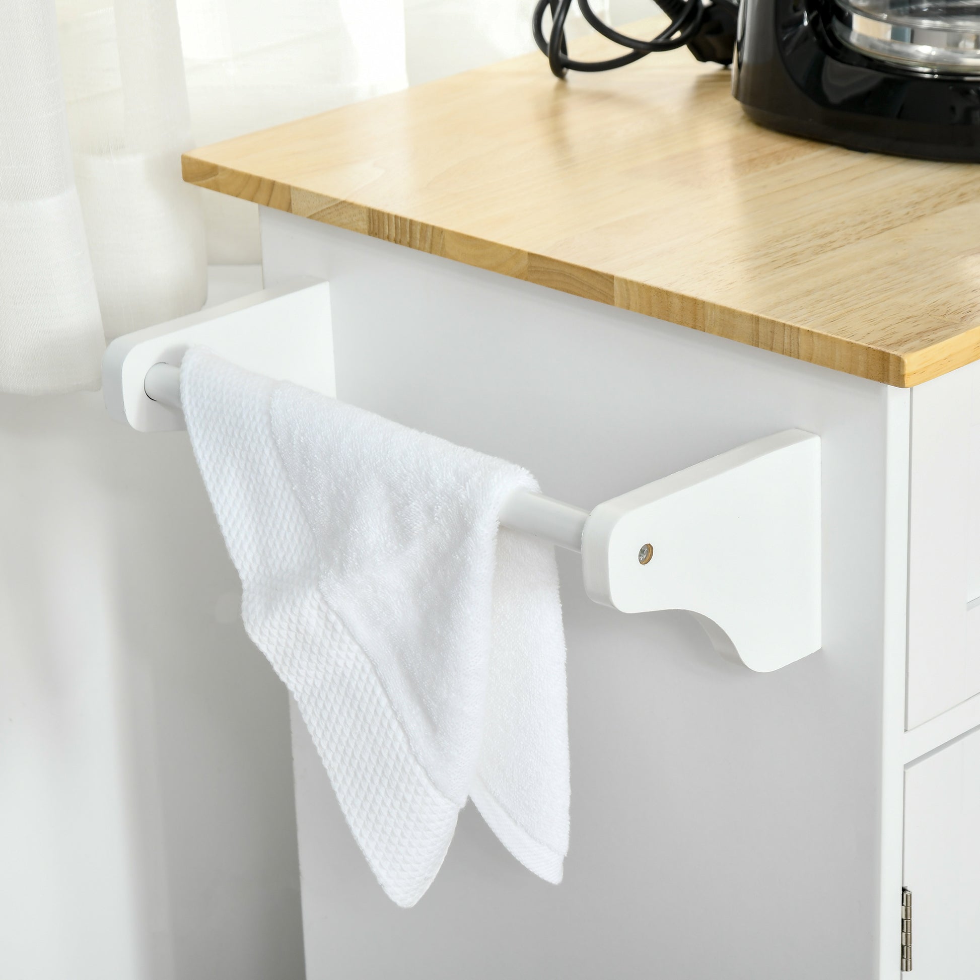 White towel bar with white textured towel hanging on a kitchen cart
