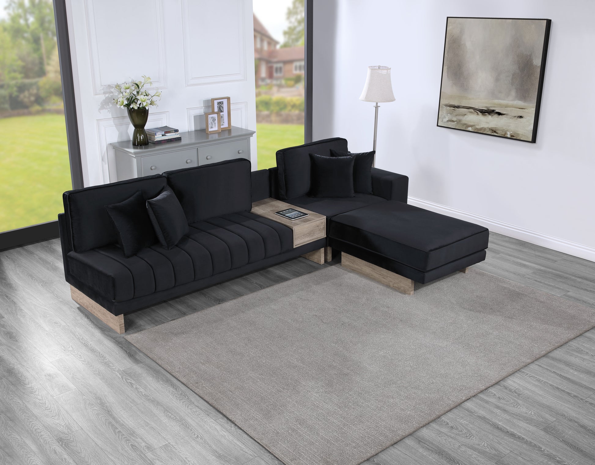 Plush black velvet sectional sofa with light wood accents and integrated side table