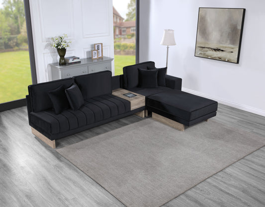 Plush black velvet sectional sofa with light wood accents and integrated side table