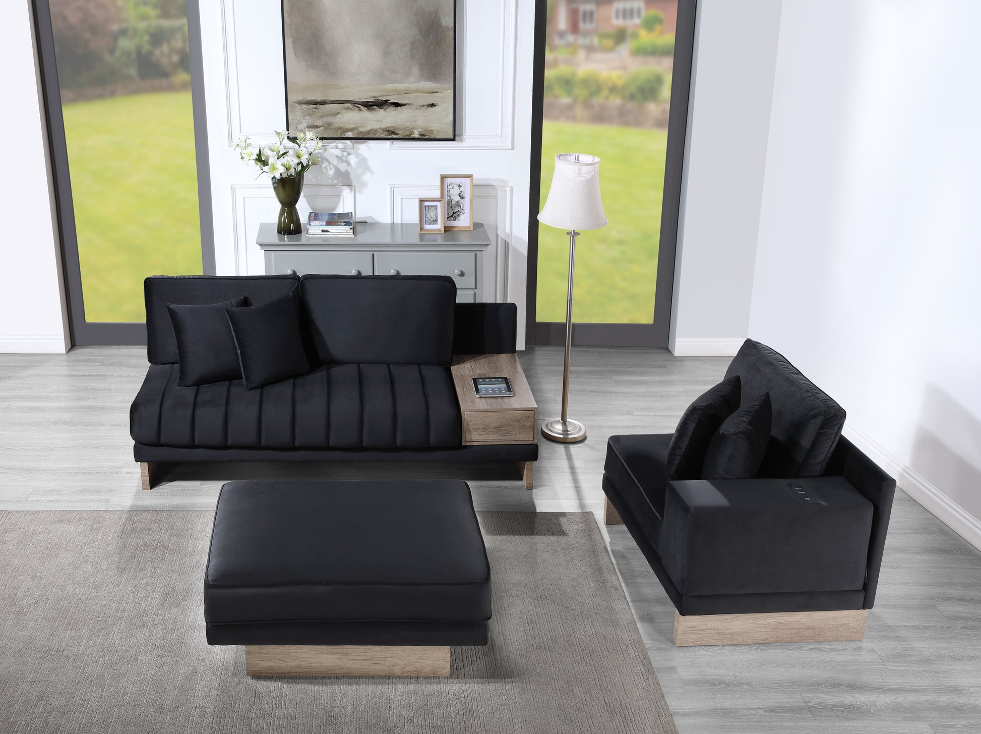 Sleek black velvet sofa with tufted cushions and integrated woodtone side table ideal for modern living rooms