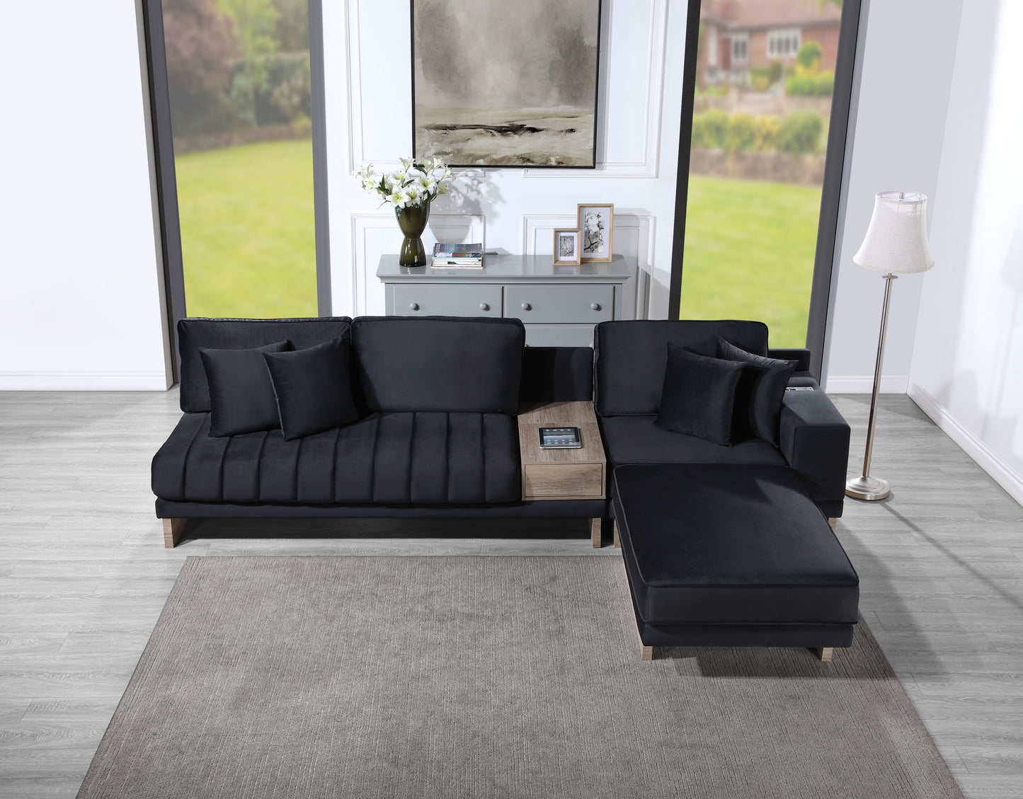 Deep charcoal velvet sectional sofa with pleated cushions and builtin wood side table