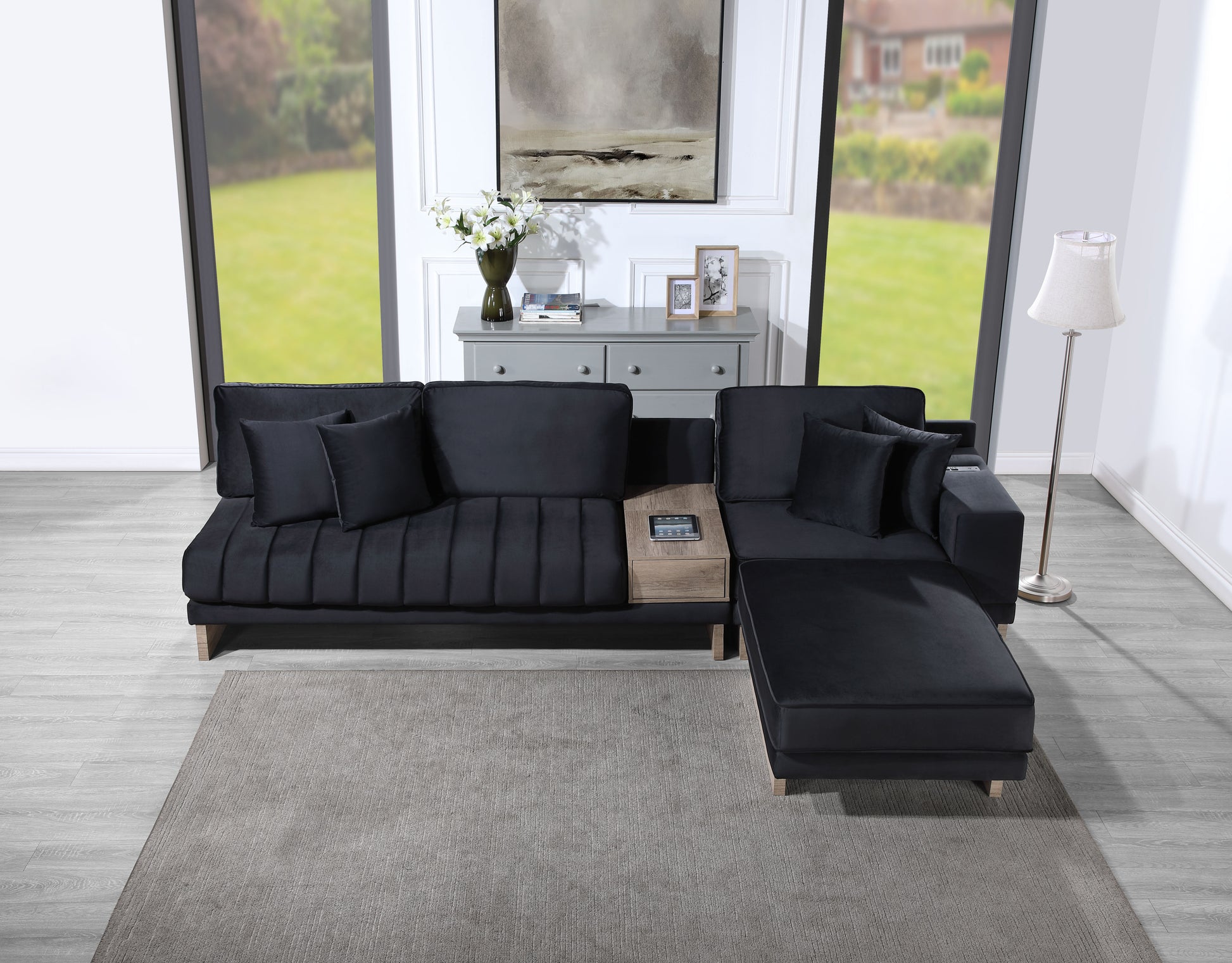 Deep charcoal velvet sectional sofa with pleated cushions and builtin wood side table