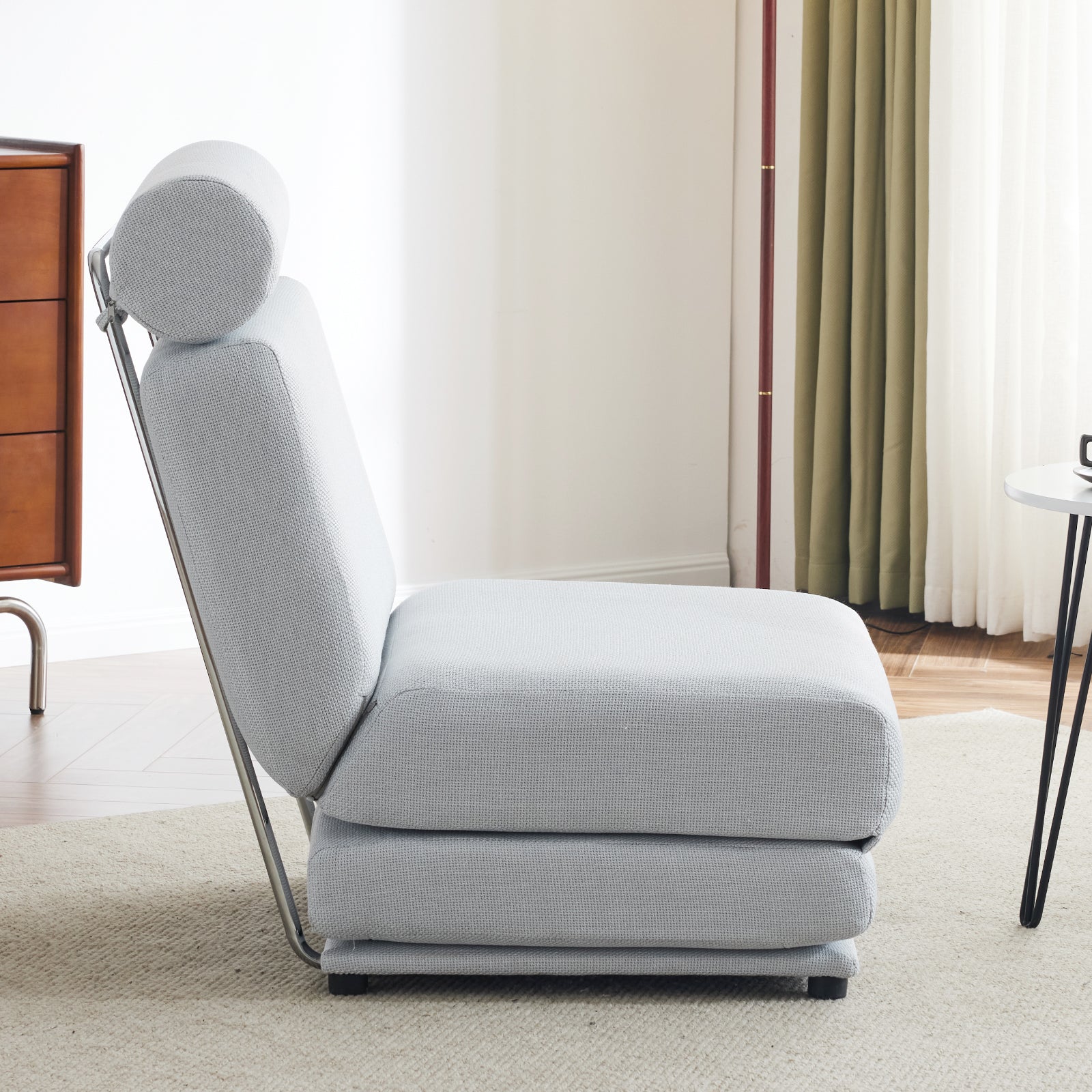 Light gray convertible chair with adjustable headrest and modern chrome frame