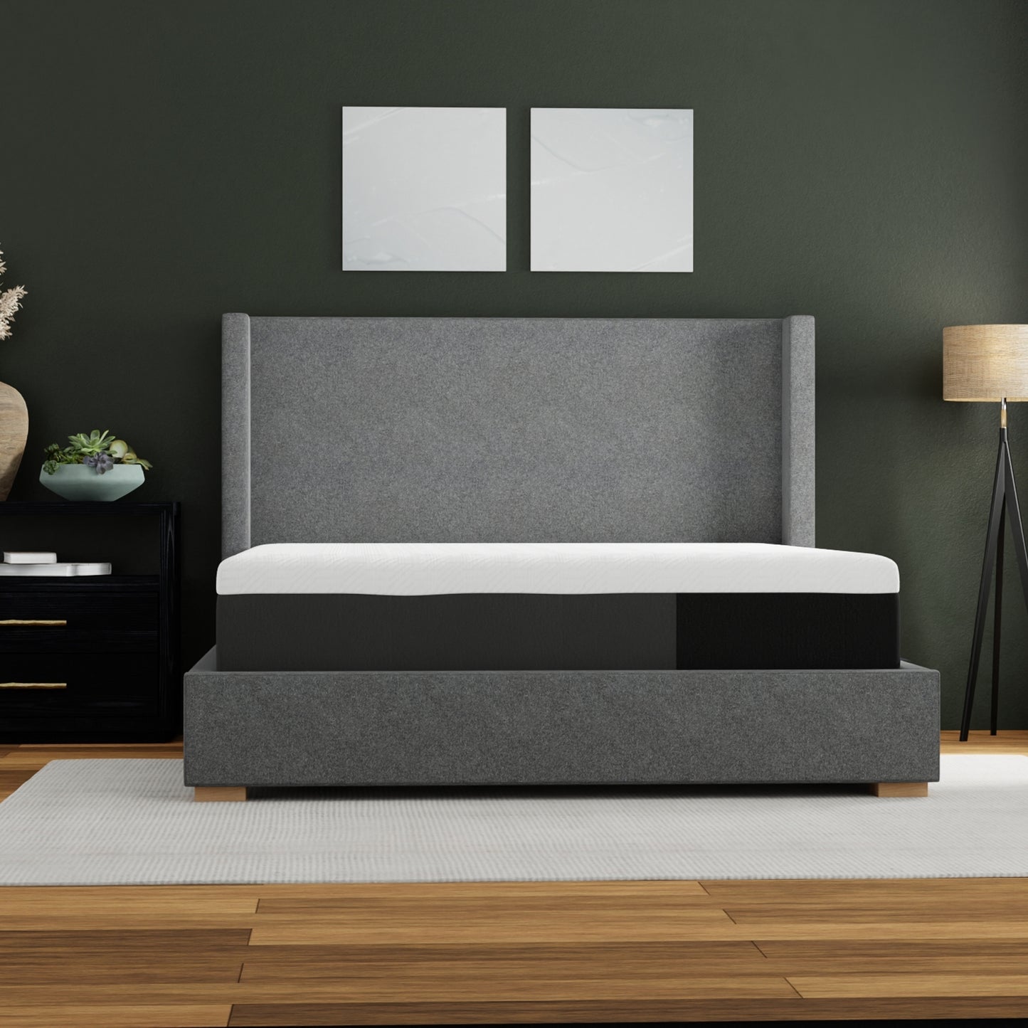 Gray upholstered bed frame with white and black mattress on platform base