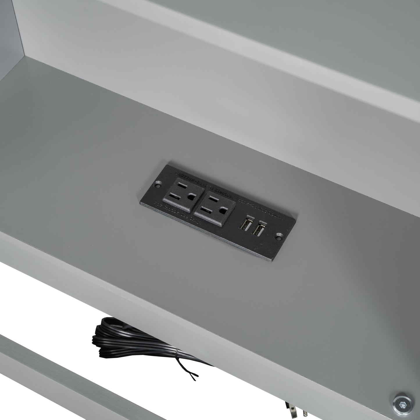 Integrated power outlet with USB ports on a gray desk