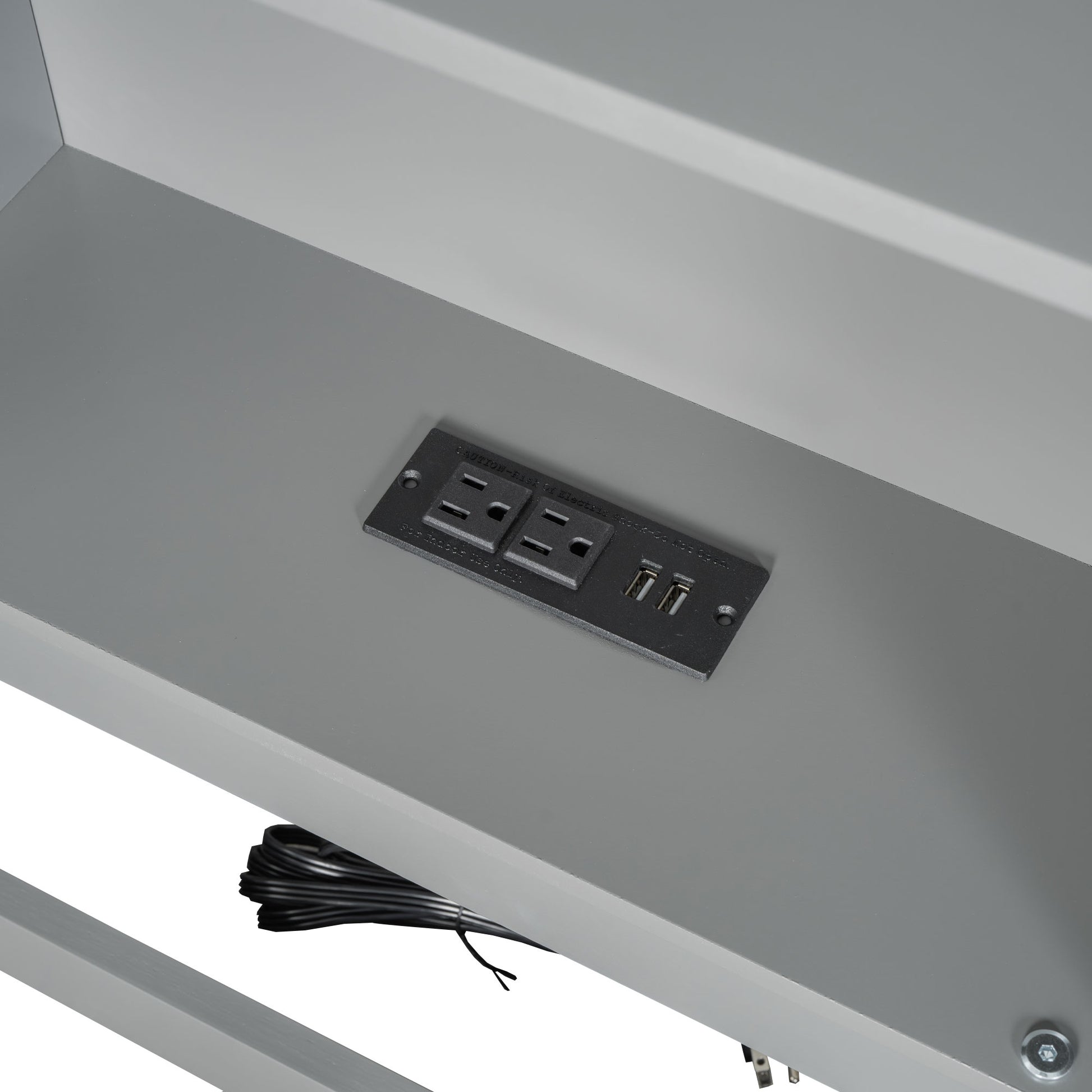 Integrated power outlet with USB ports on a gray desk