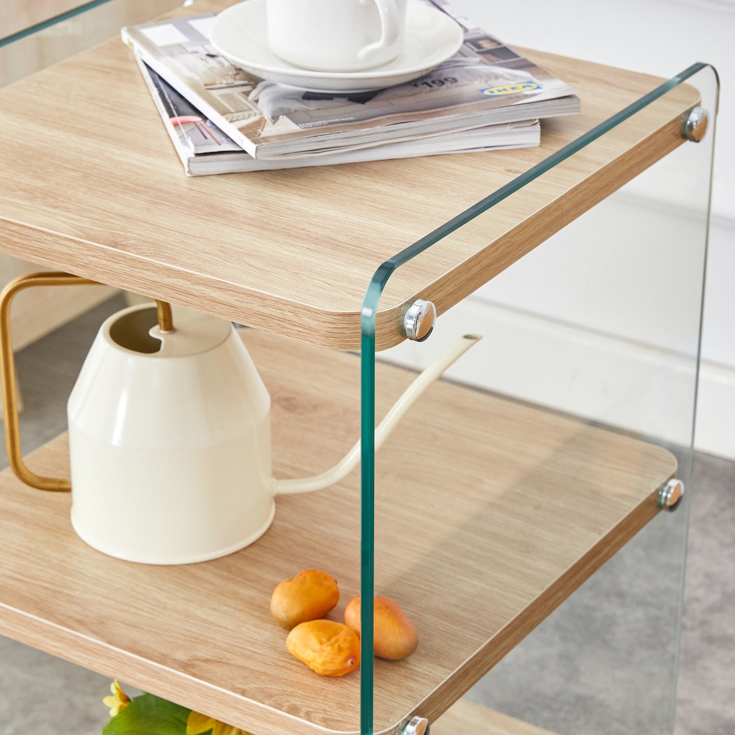 Wooden bedside table with glass sides and a watering can