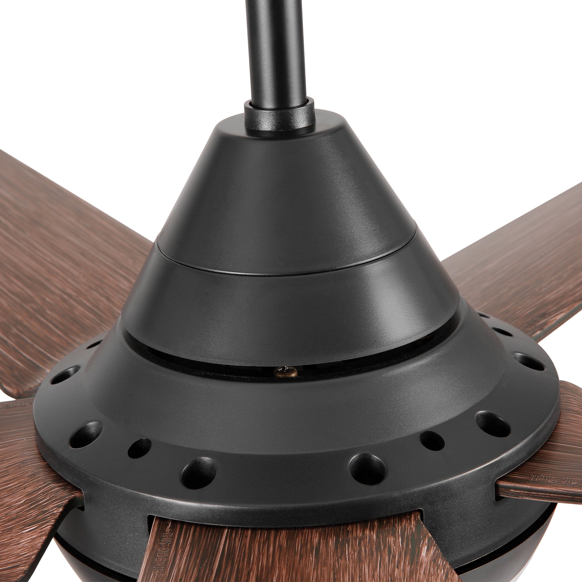 Closeup of a black motor housing with wooden grain fan blades on a ceiling fan