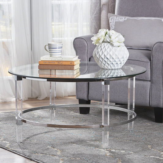 Round glass coffee table with clear acrylic legs and chrome accents