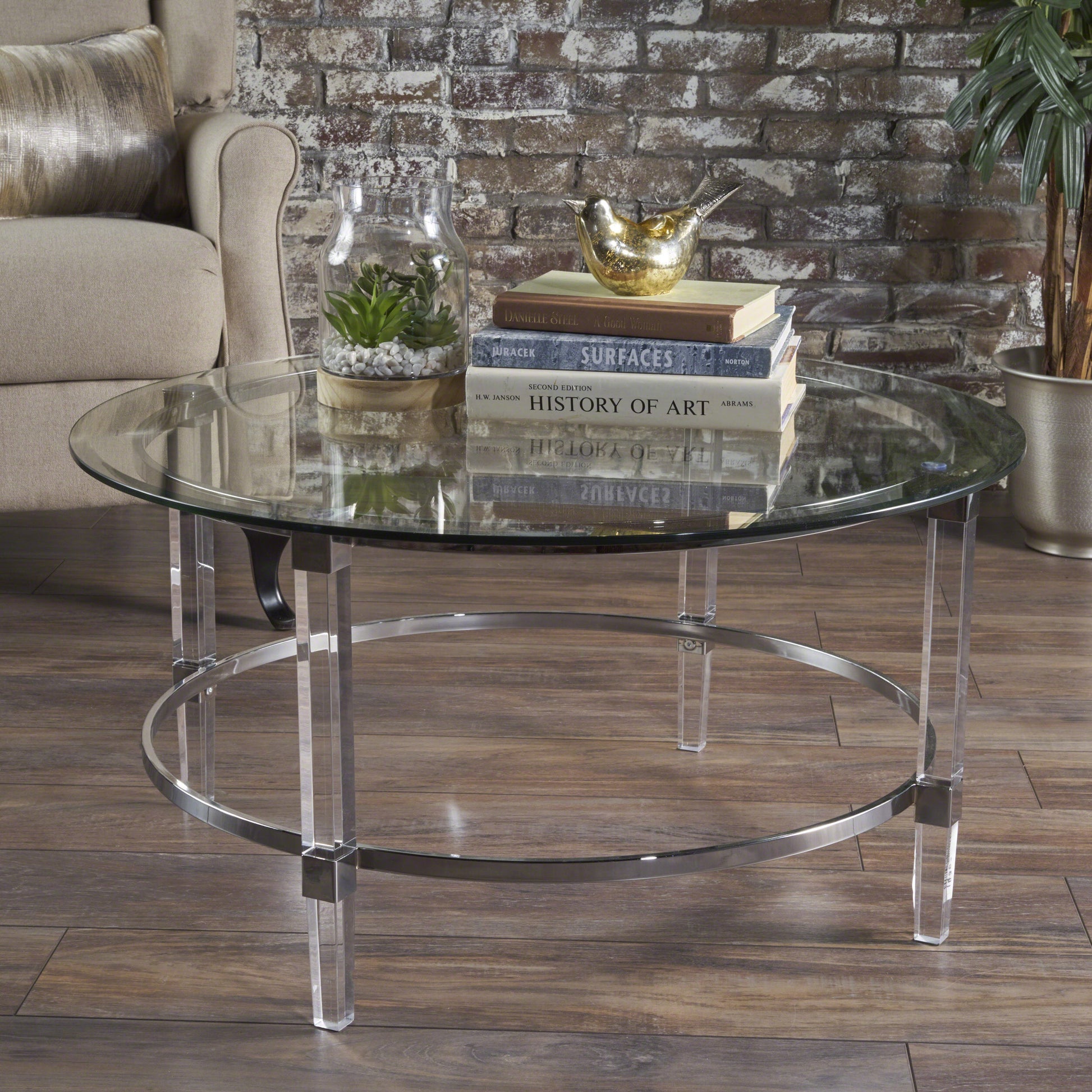Clear glass round coffee table with acrylic legs and chrome ring accent
