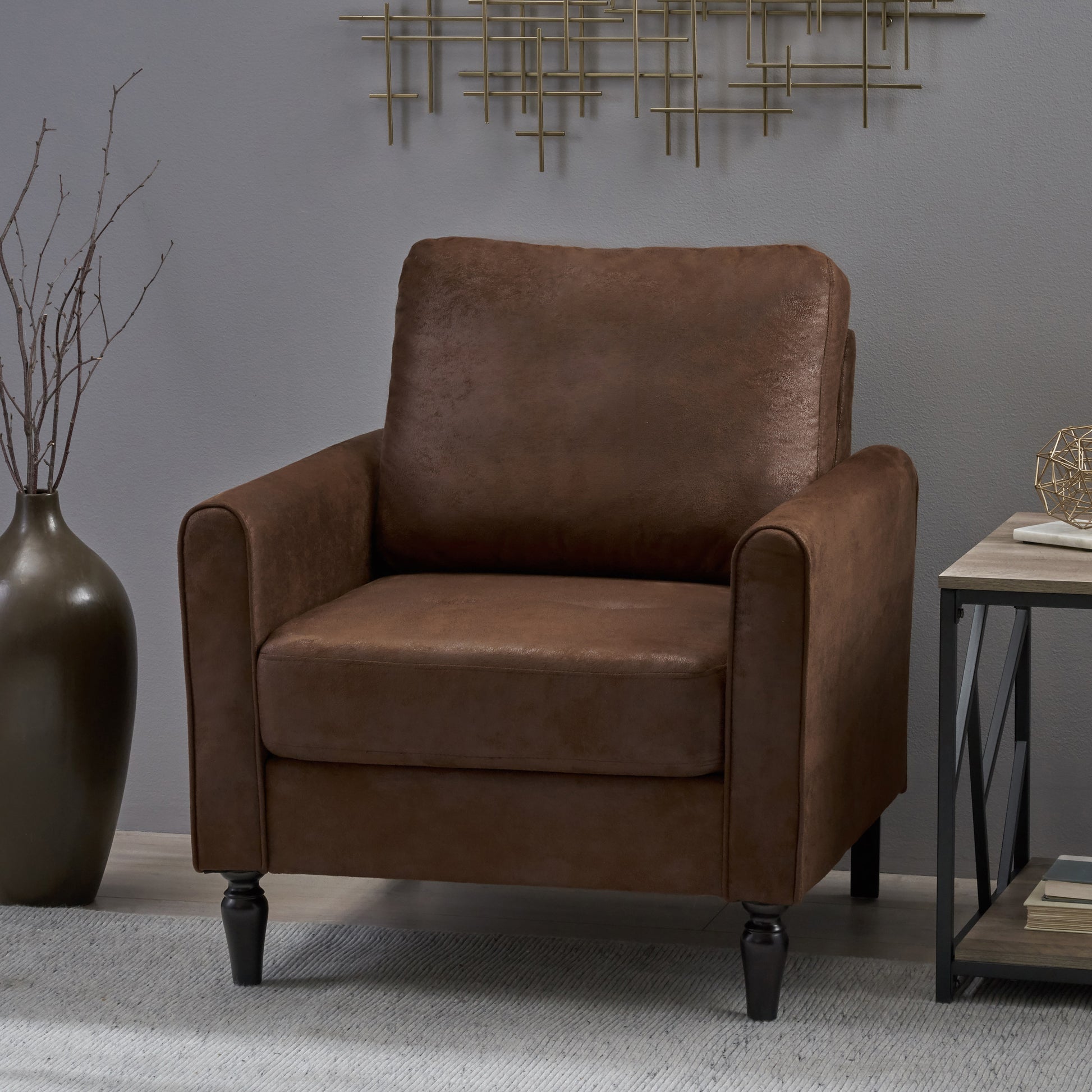 Brown faux leather armchair with plush seating and dark wooden legs