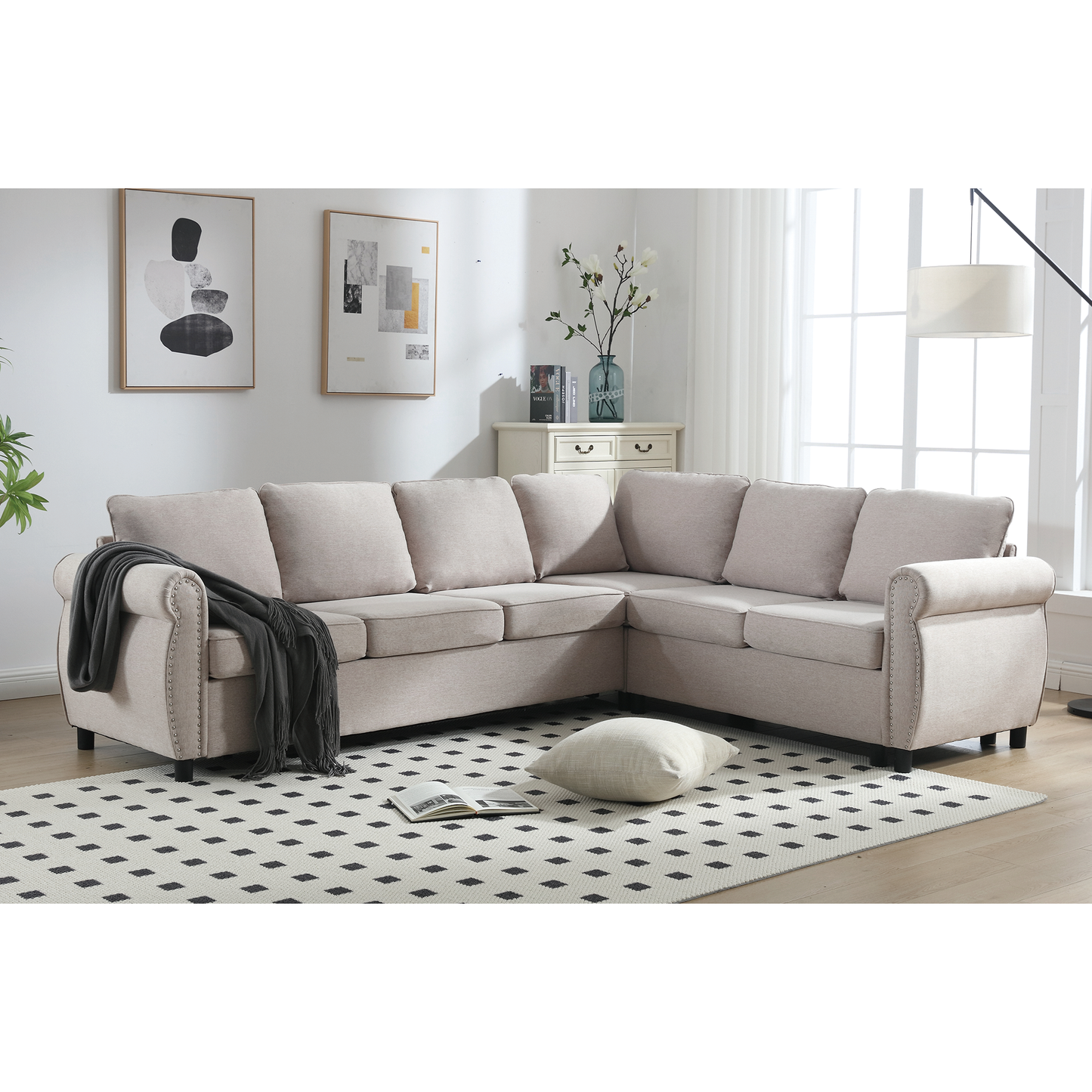 Light beige fabric sectional sofa with rolled arms and nailhead trim perfect for living room seating