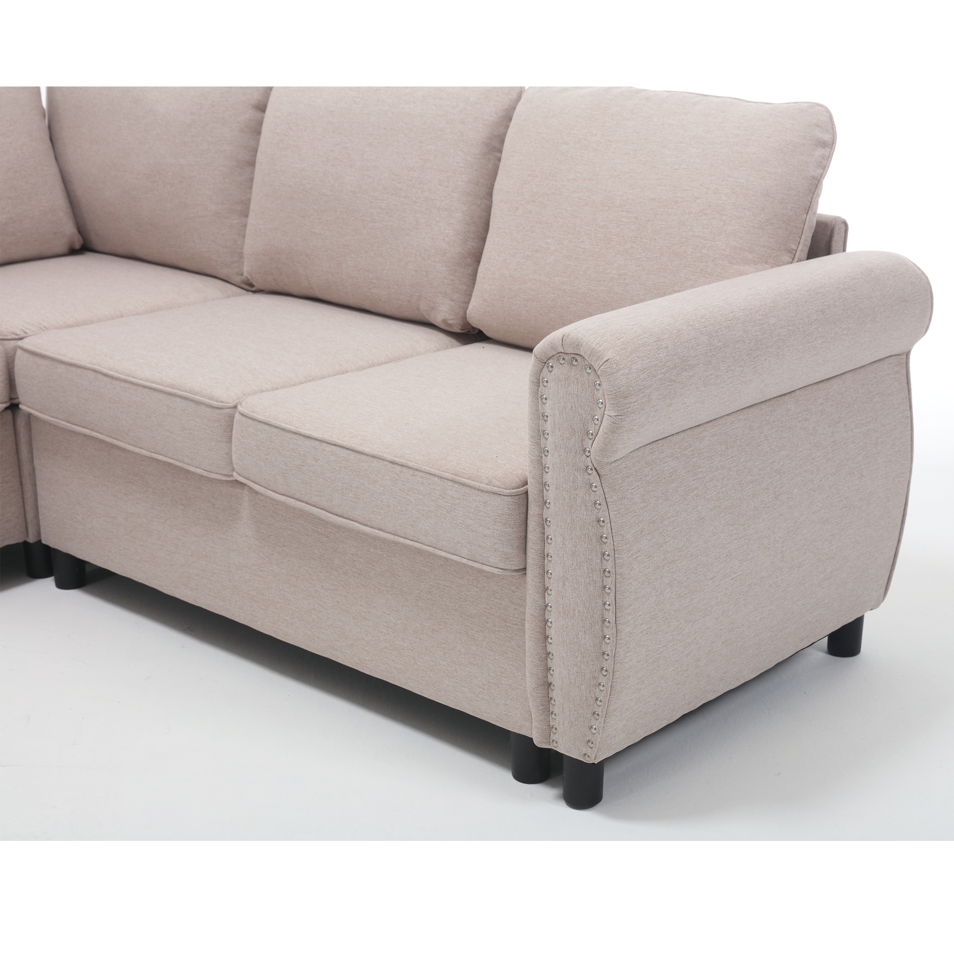 Sectional sofa in beige fabric with decorative nailhead trim on the armrest