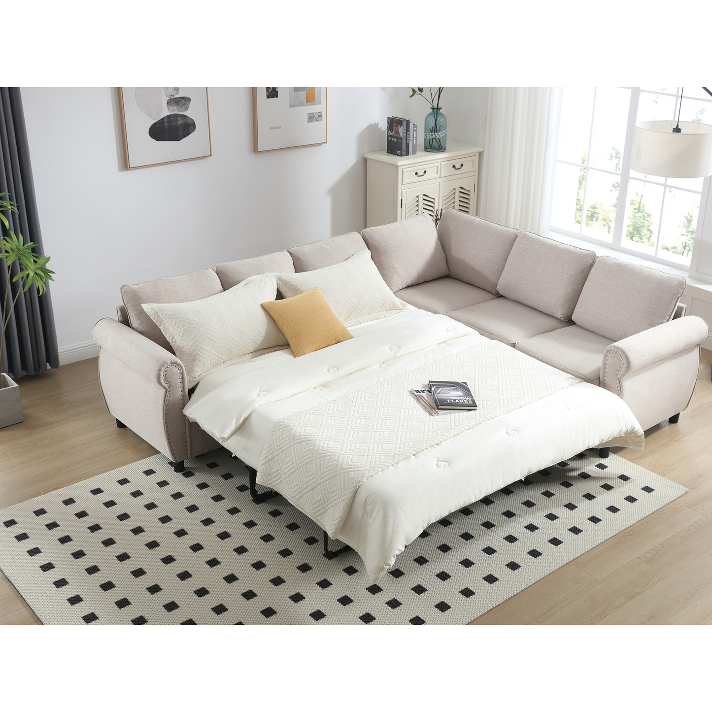 Beige sectional sofa bed with white bedding and a yellow accent pillow
