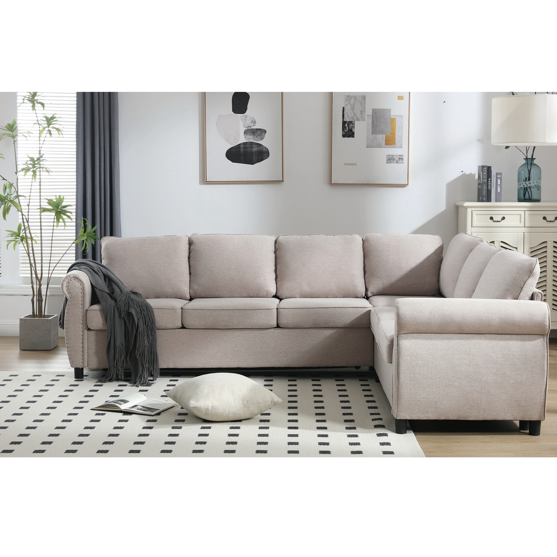 Light beige upholstered sectional sofa with tufted armrests and plush cushions