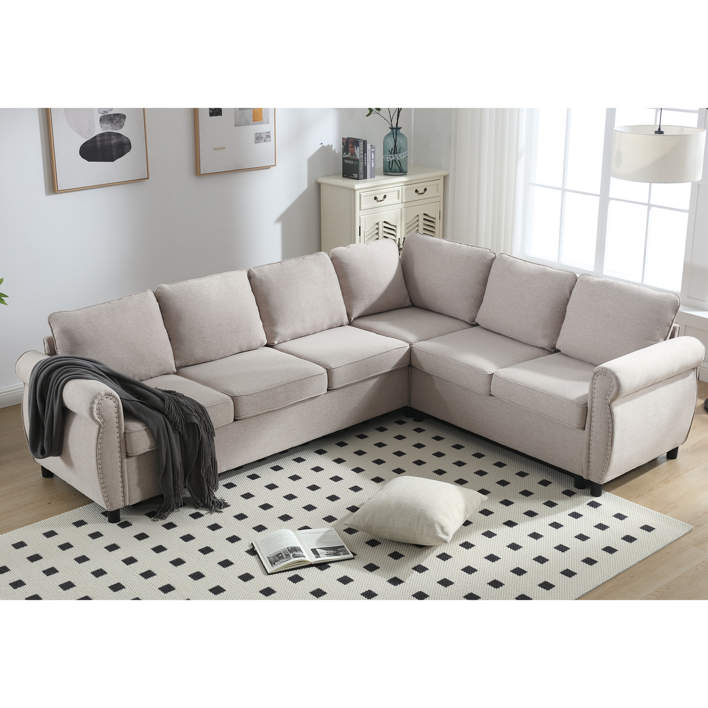 Neutral beige linen sectional sofa with rolled arms and nailhead trim