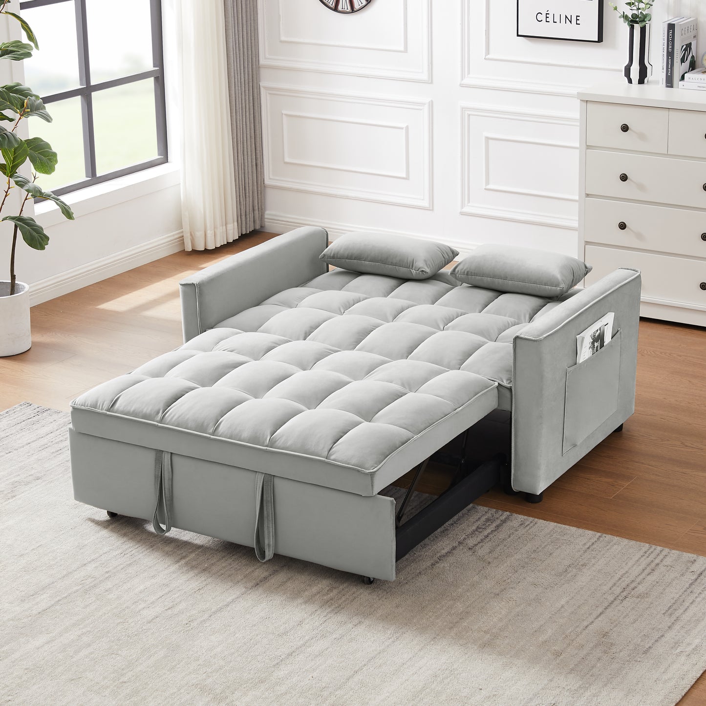 Grey velvet sofa bed with tufted cushions and side storage pocket