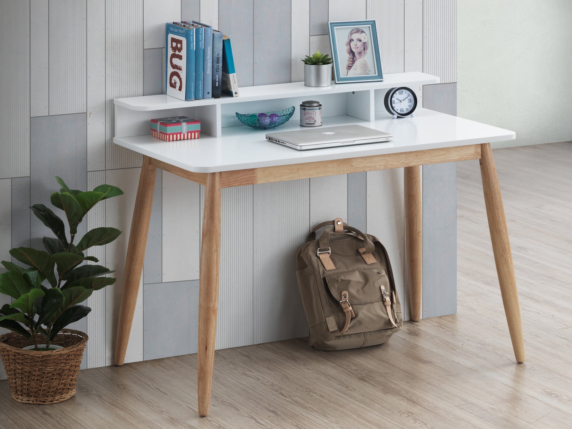 Compact white desk with modern light wood legs and tiered shelving