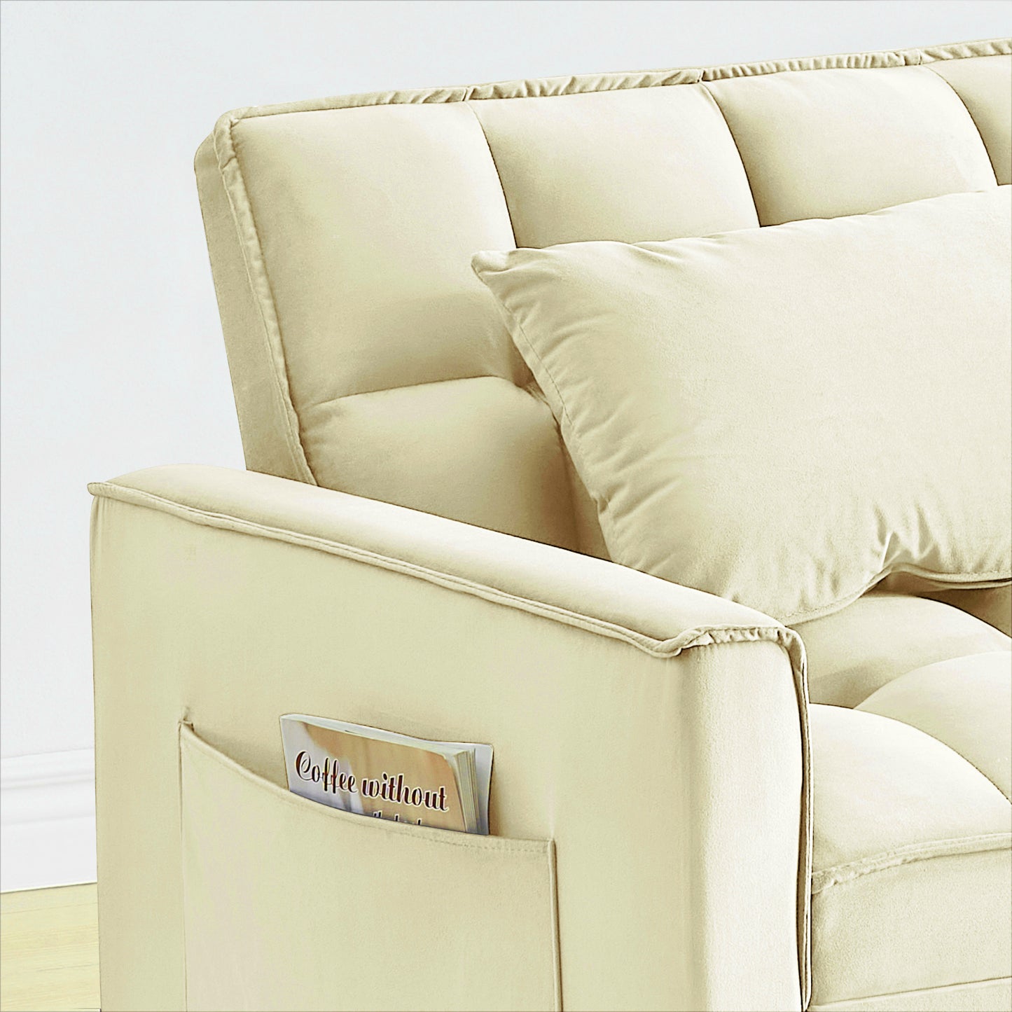 Cream velvet sofa armrest with side pocket holding a magazine comfortable and stylish