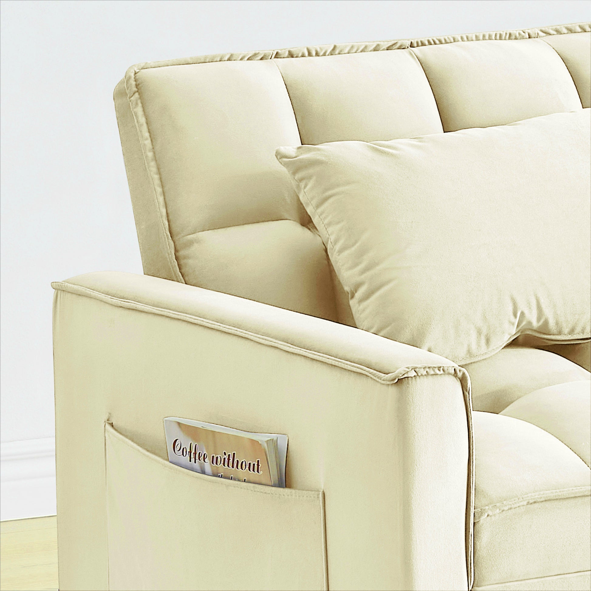 Cream velvet sofa armrest with side pocket holding a magazine comfortable and stylish