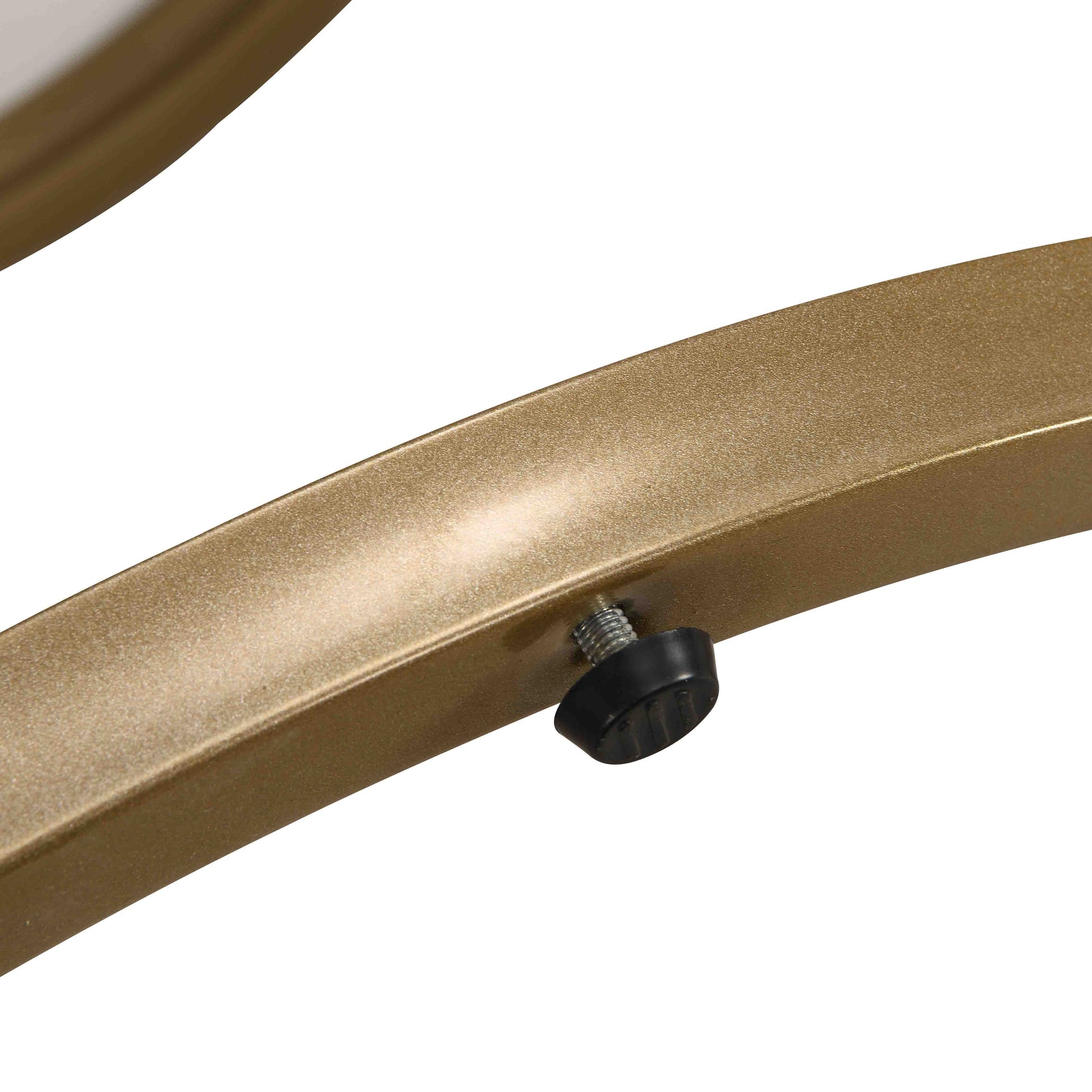 Closeup of a gold metal leg with adjustable black footpad part of a modern side table