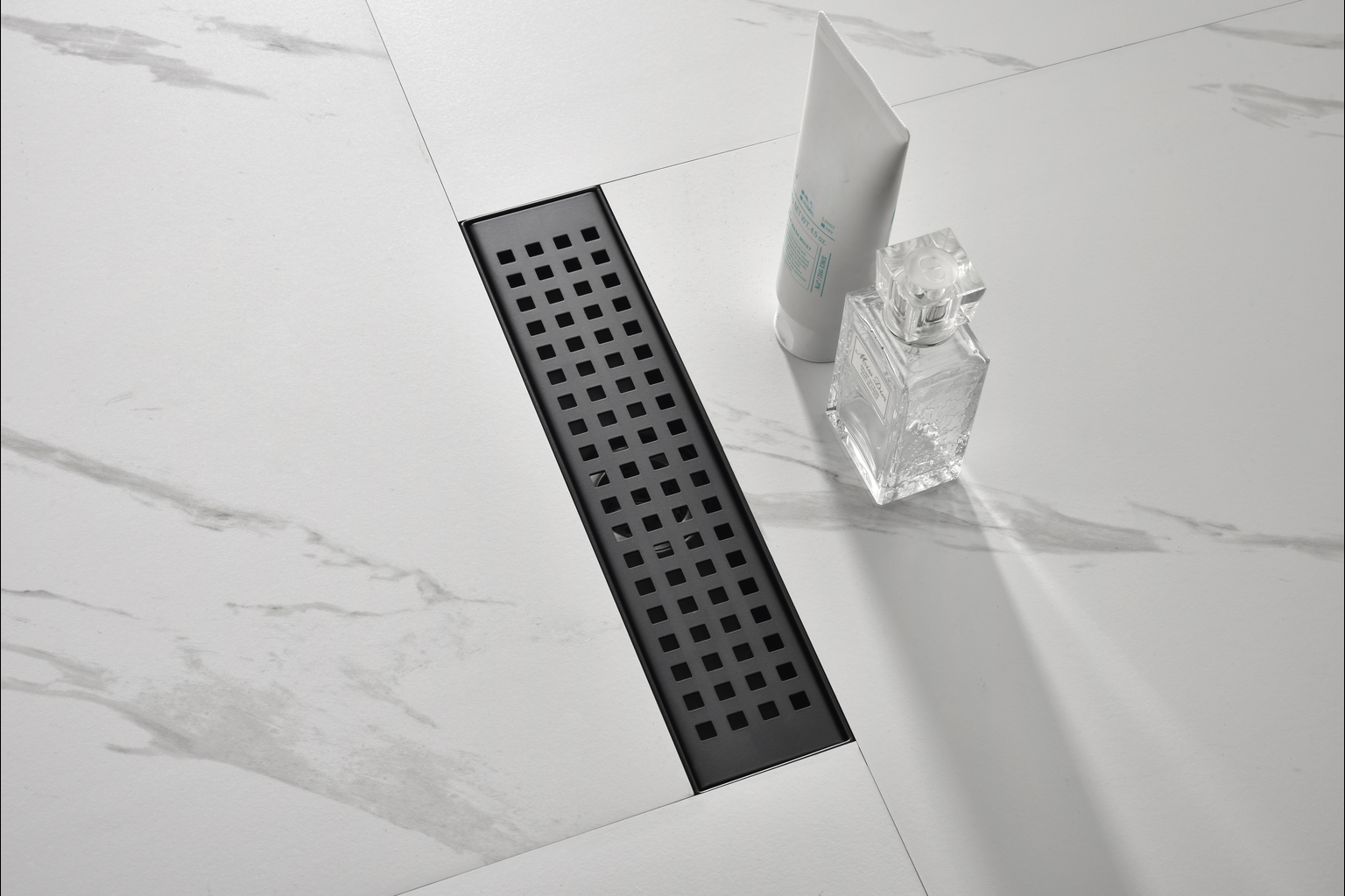 Modern black linear shower drain with a minimalist square grate design